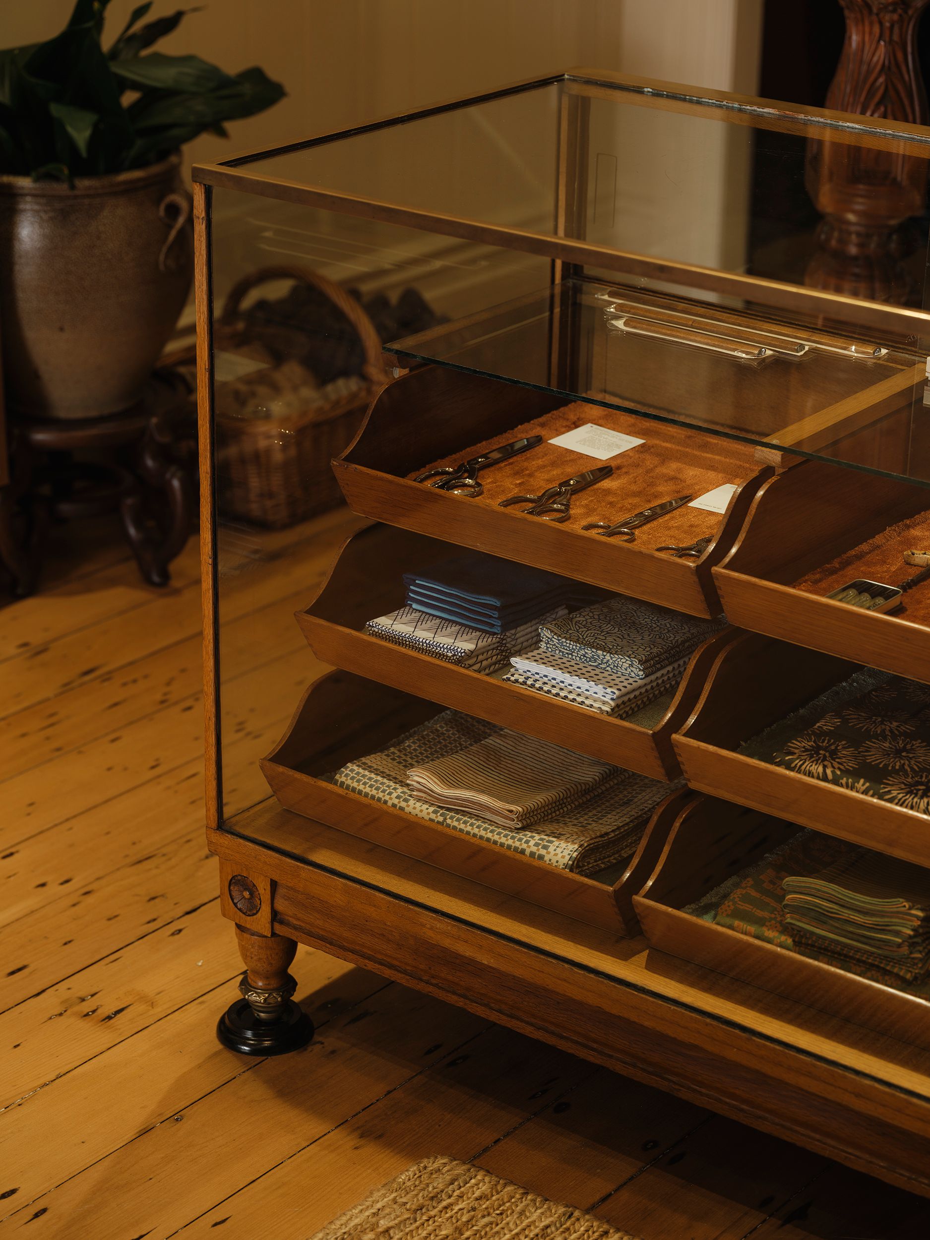 Antique haberdashery display cabinet displaying Niwaki Japanese garden tools, Ernest Wright scissors, Studio Ford textiles and handcrafted objects at Handcrafted Modern in Ponsonby, Auckland.