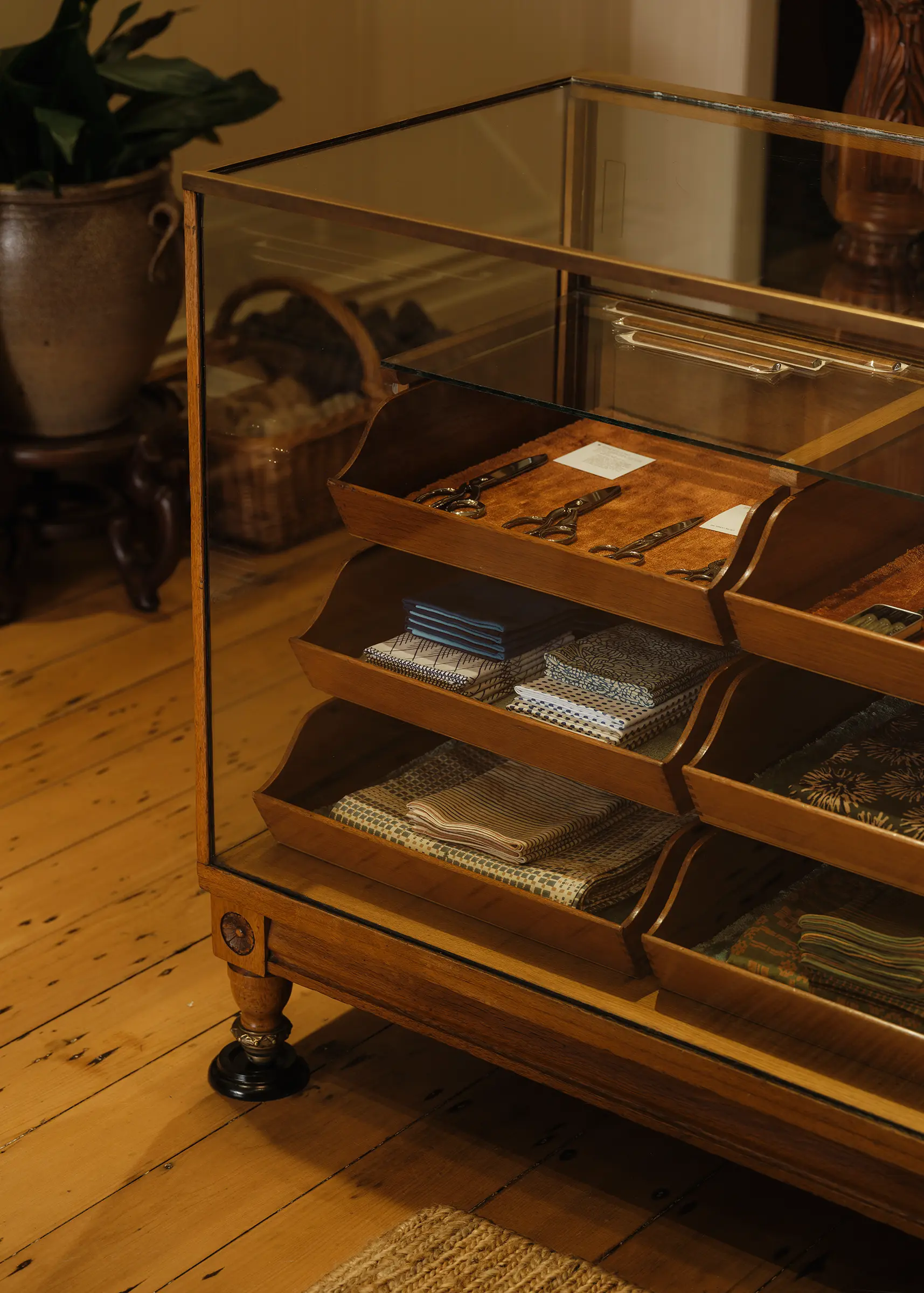 Antique haberdashery display cabinet displaying Niwaki Japanese garden tools, Ernest Wright scissors, Studio Ford textiles and handcrafted objects at Handcrafted Modern in Ponsonby, Auckland.