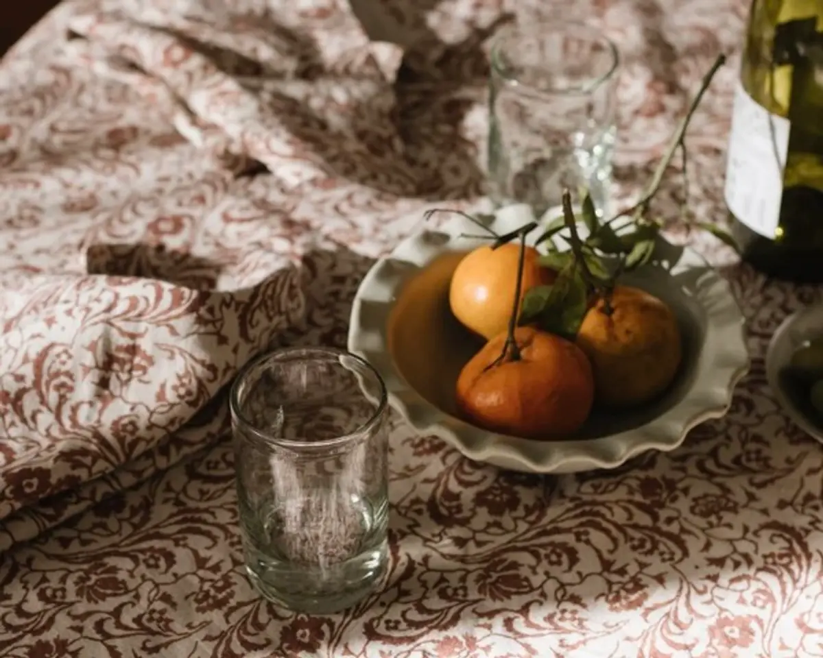 Ingrid linen placemat on a table with fruit bowl, wine bottle and glasses