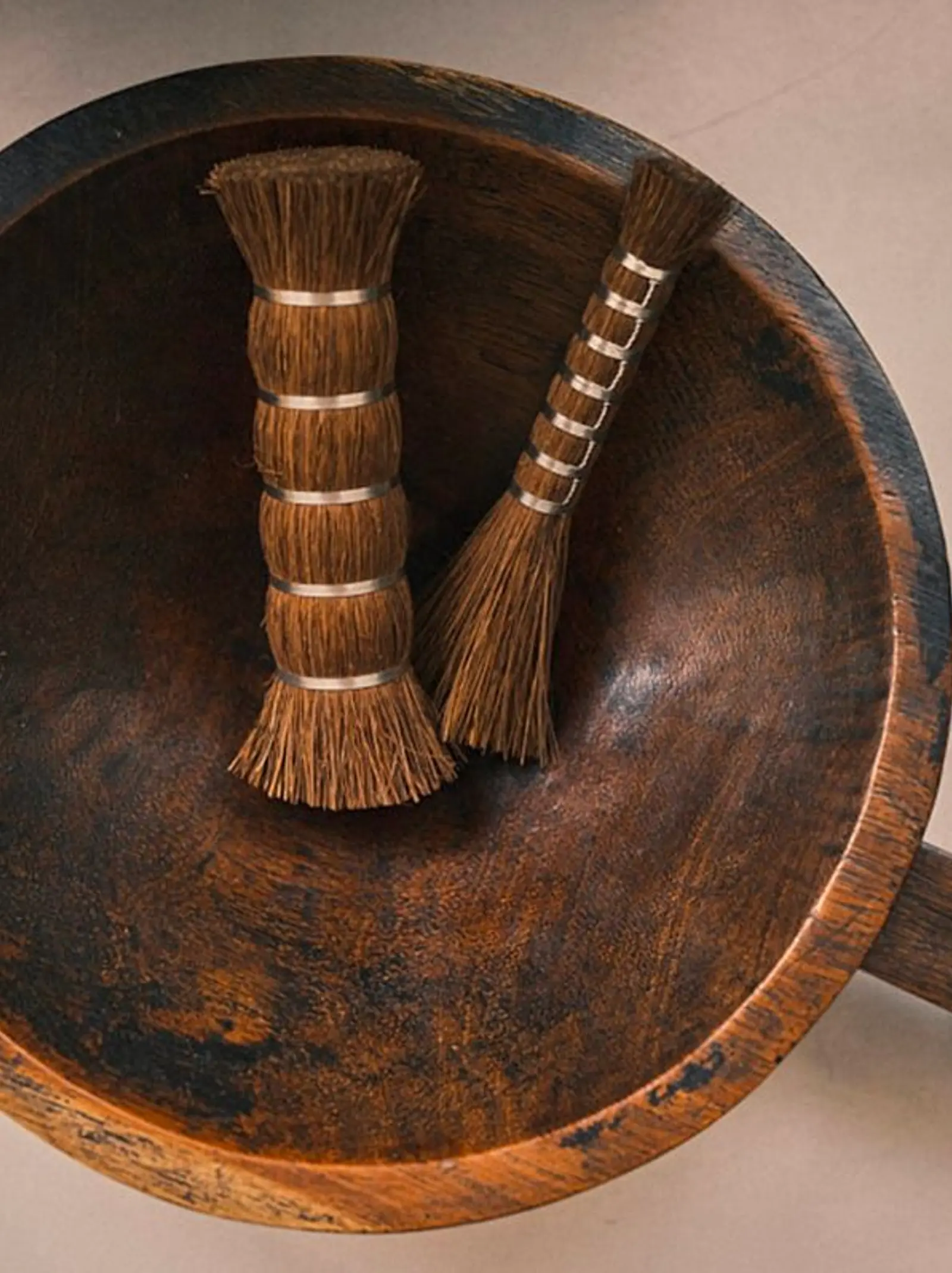 Takada Tawashi handled broom handcrafted in Japan from natural palm fibre, hanging on a timber wall and showcasing traditional Japanese craftsmanship, available at Handcrafted Modern.