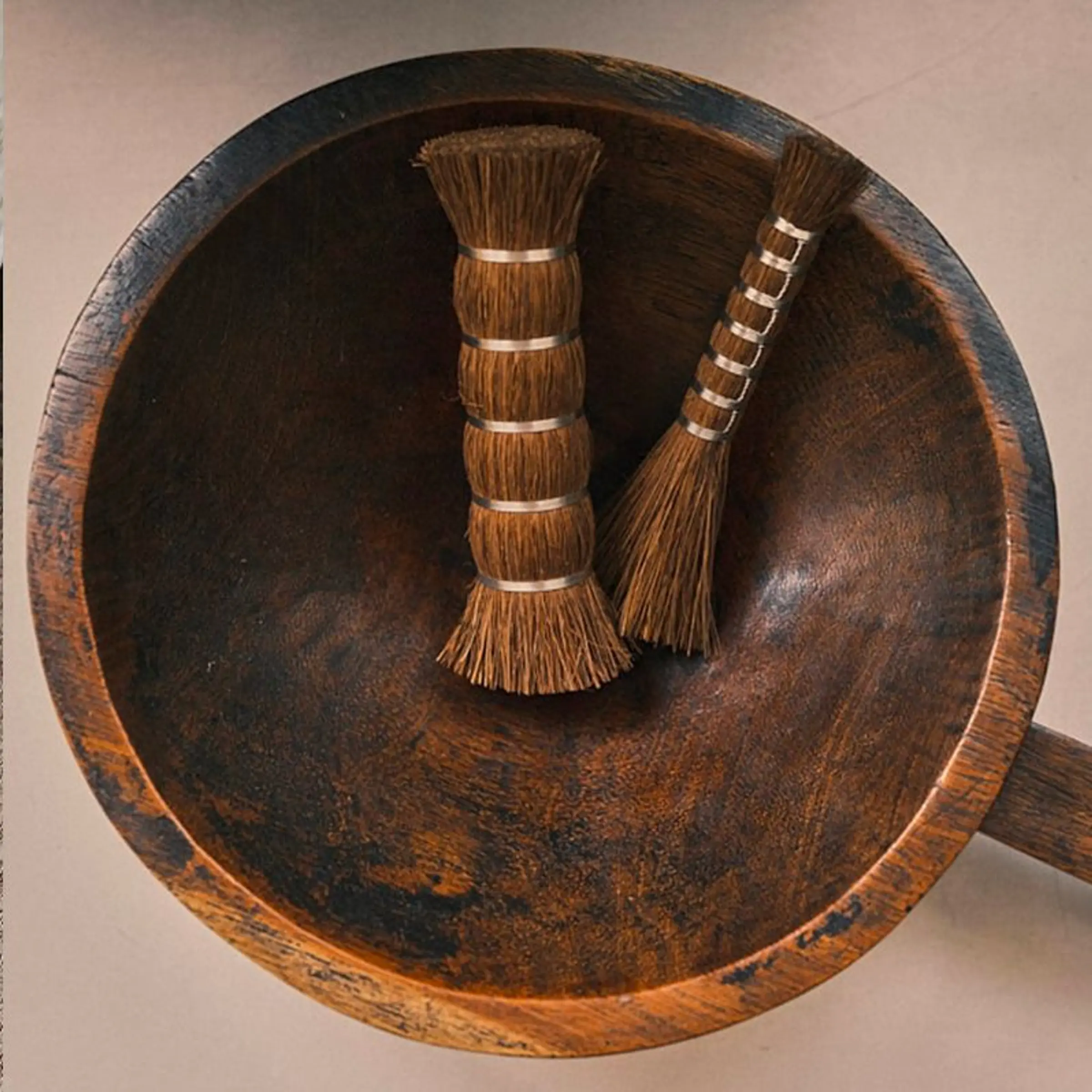 Takada Tawashi handled broom handcrafted in Japan from natural palm fibre, hanging on a timber wall and showcasing traditional Japanese craftsmanship, available at Handcrafted Modern.