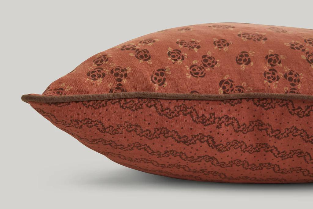 a close up of the studio ford marquise lumbar cushion in rust and cocoa colours