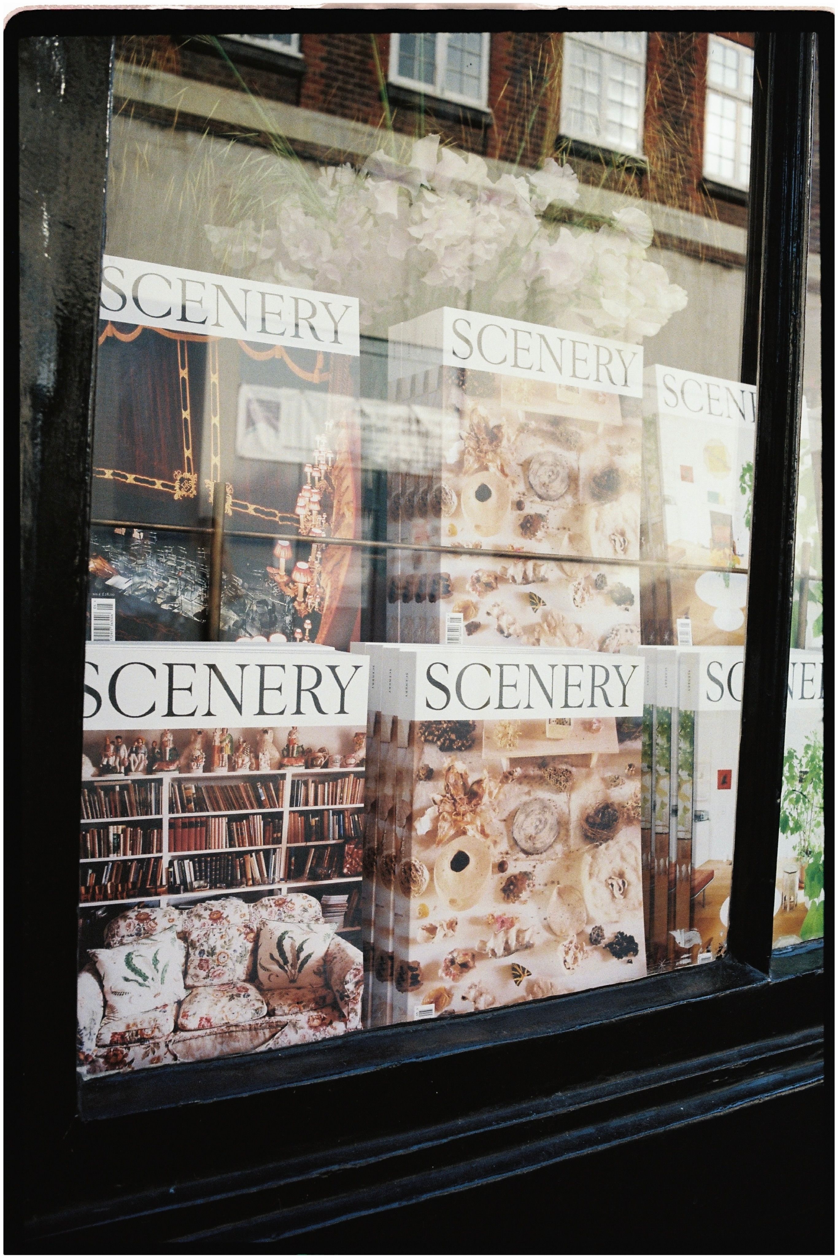 A picture from scenery magazine of their issue 5 launch with their magazines lined up in the window of Johns and doe books