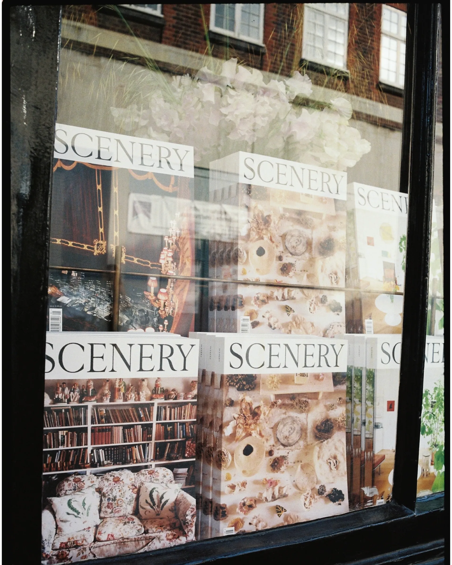 A picture from scenery magazine of their issue 5 launch with their magazines lined up in the window of Johns and doe books