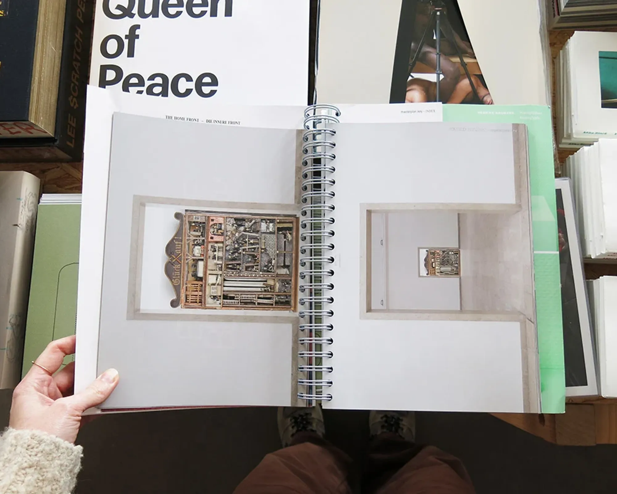 Henrike Naumann: Die Innere Front / The Home Front open to a spiral-bound exhibition spread featuring an installation from the German Pavilion at the Venice Biennale.