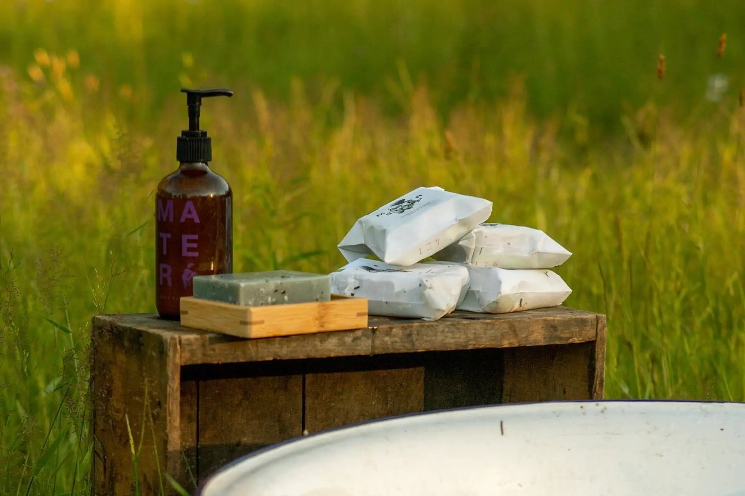 mater soap on a wooden table in a grass field