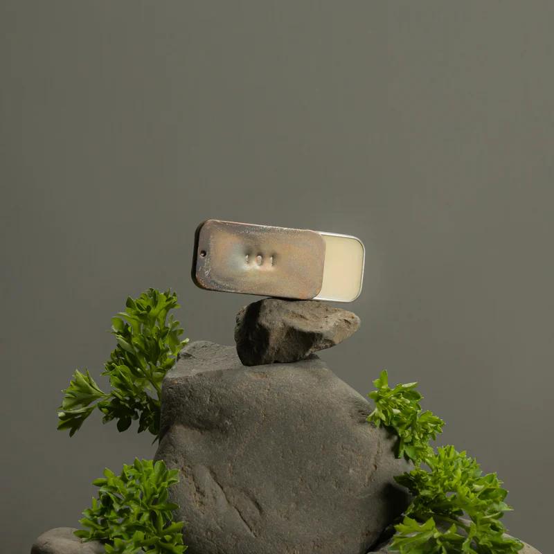 A hand stamped tin of Solid perfume from Fischersund made in Iceland, vegan hand crafted scents