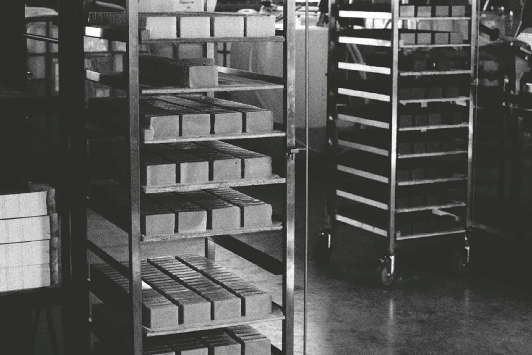 metal racks storing bars of soap being cold pressed
