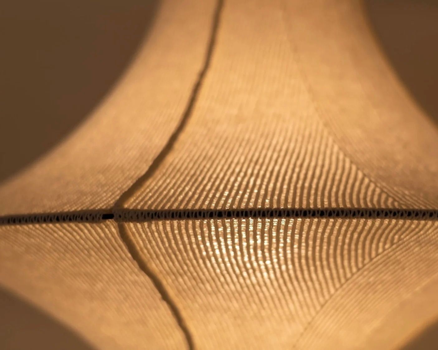 Close-up of the LOF HIWA wool pendant light handcrafted from New Zealand Romney wool, showcasing the knitted textile construction that diffuses light and creates warm, sculptural interior lighting.