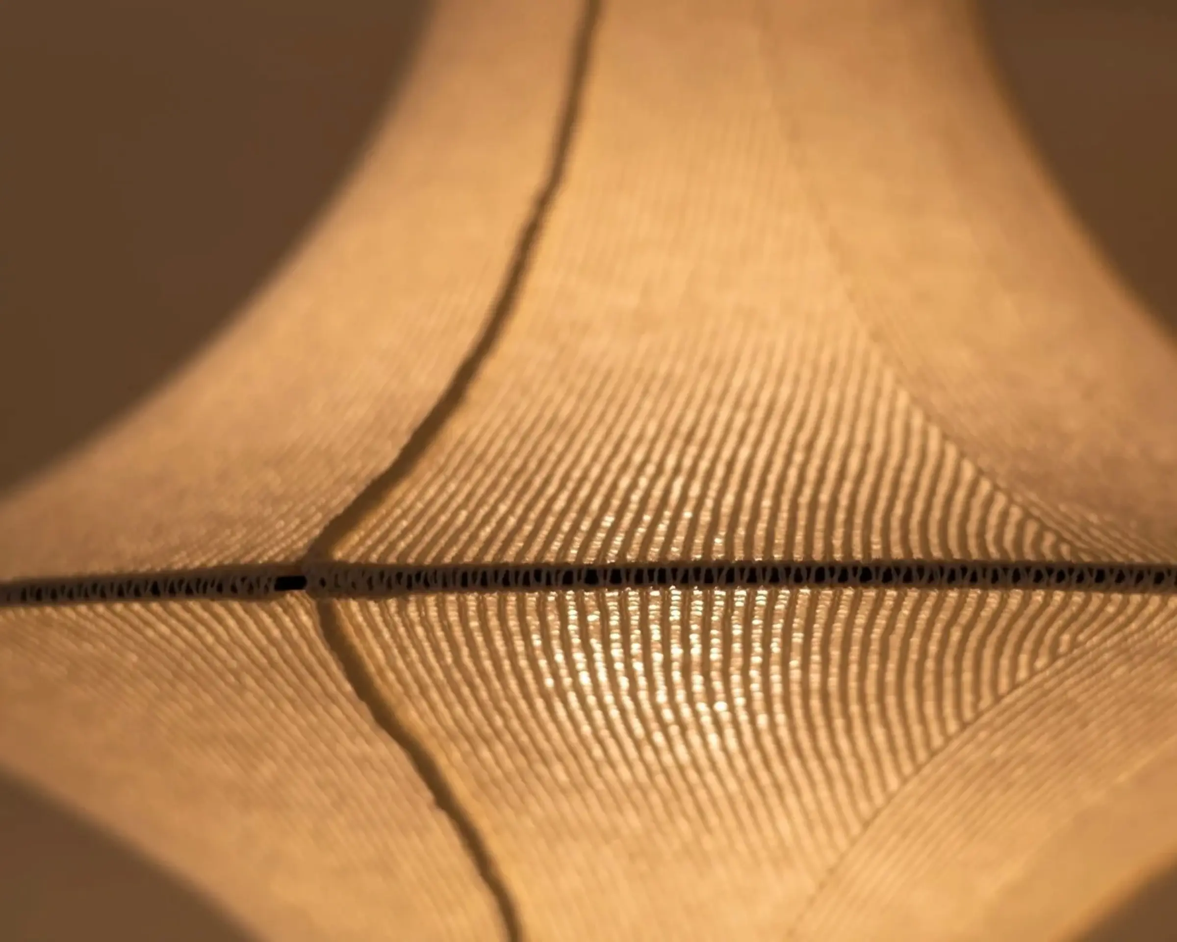 Close-up of the LOF HIWA wool pendant light handcrafted from New Zealand Romney wool, showcasing the knitted textile construction that diffuses light and creates warm, sculptural interior lighting.