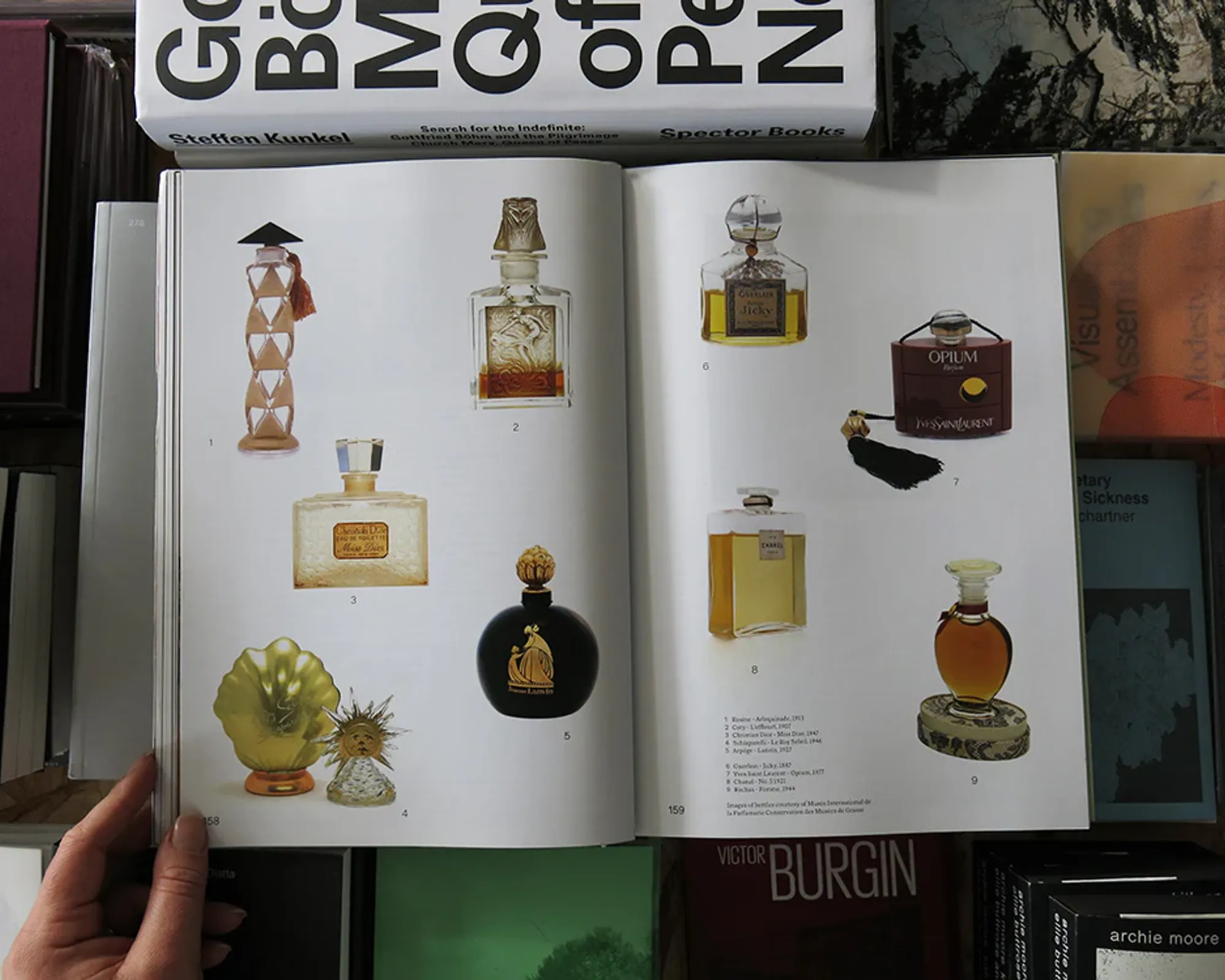 An image from inside of The Viscose 07: Scent book showing a collage of vintage perfume bottles