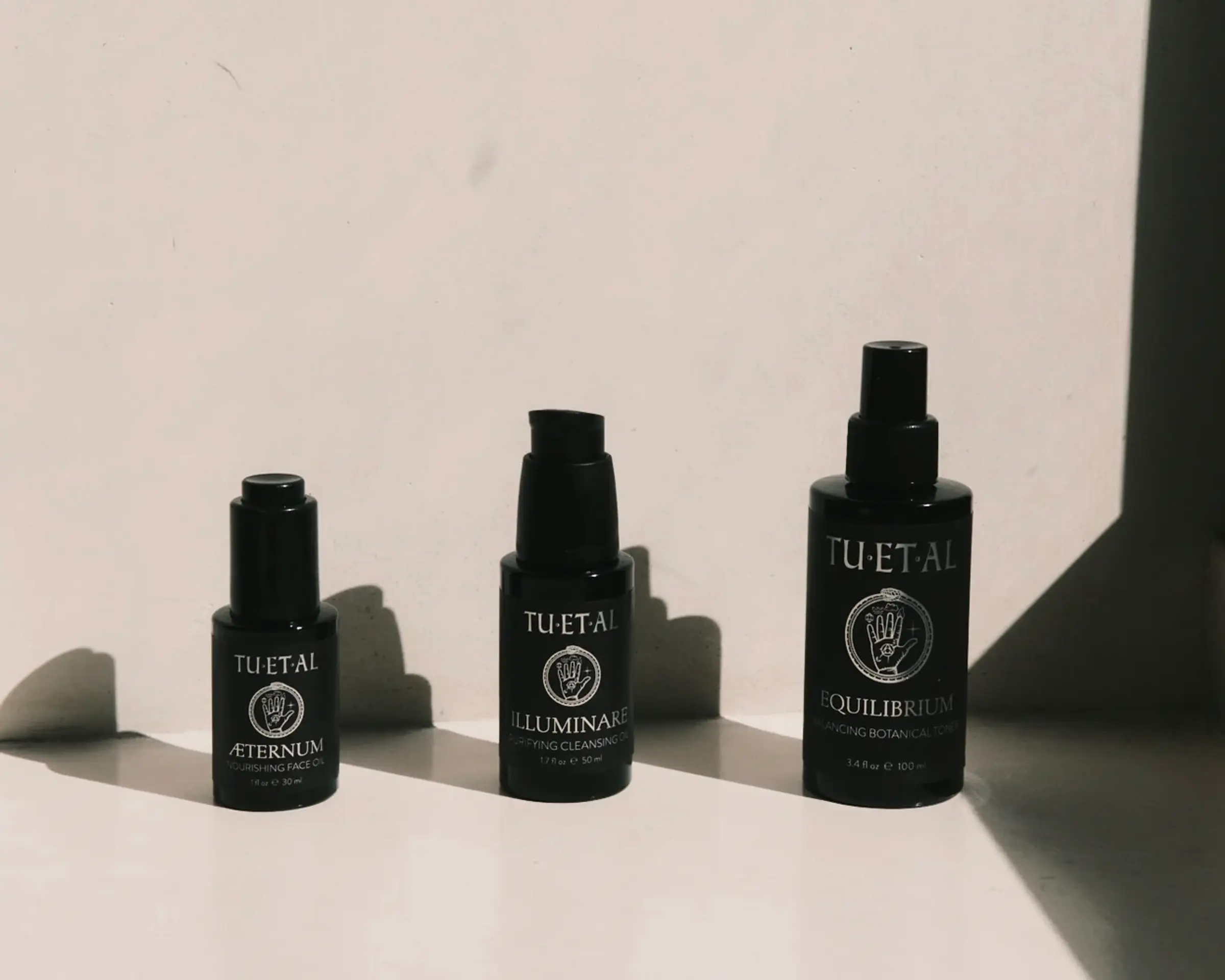 tuetal beauty trio of toner, cleansing oil and face oil on a cream background