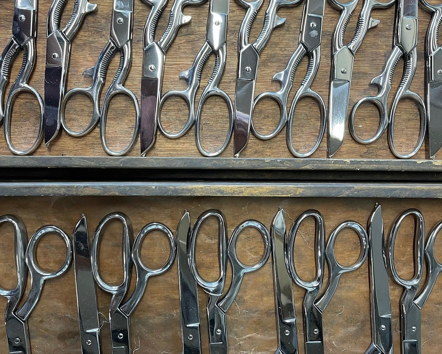 handmade scissors laying in a wooden tray
