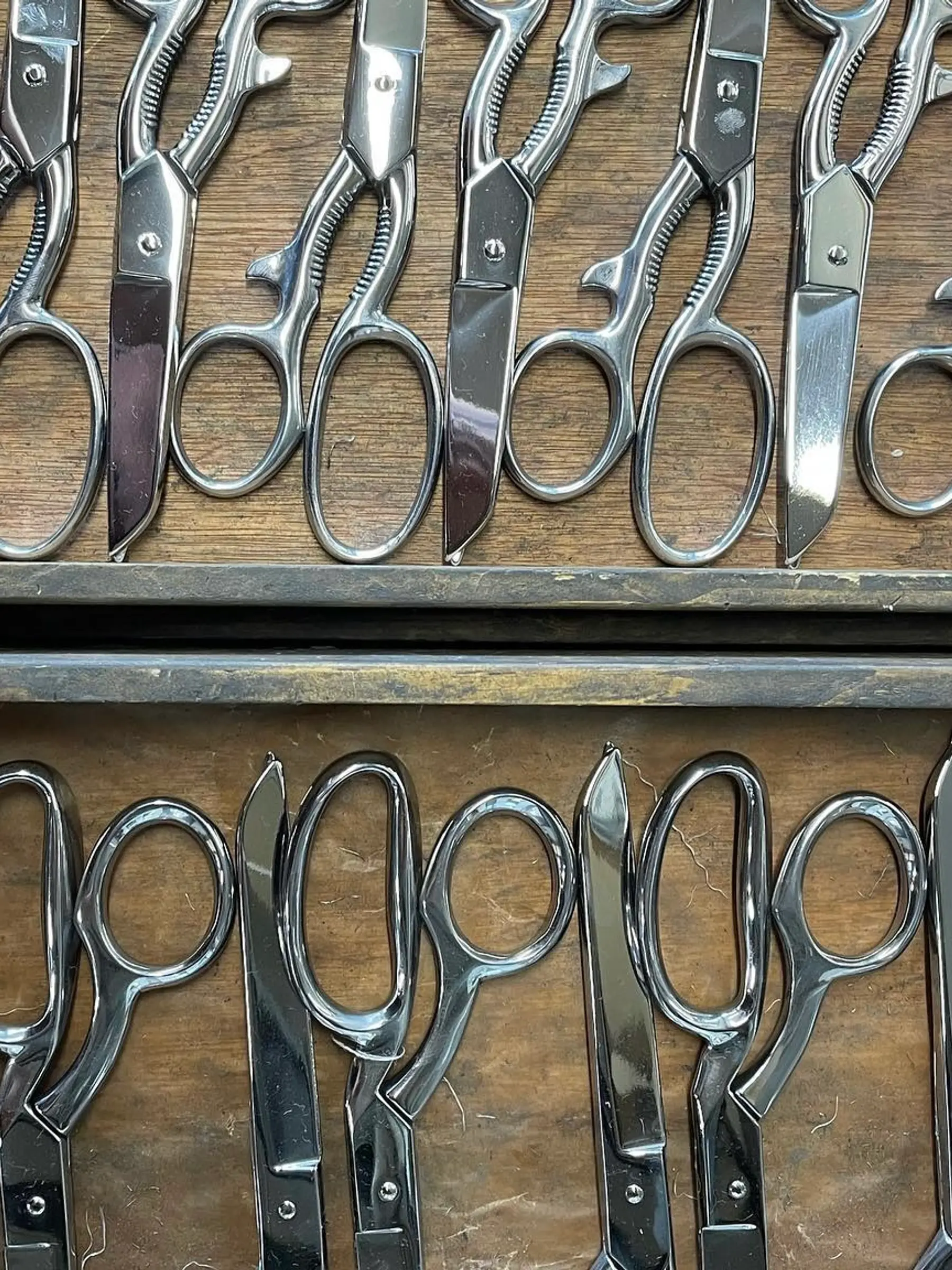 handmade scissors laying in a wooden tray