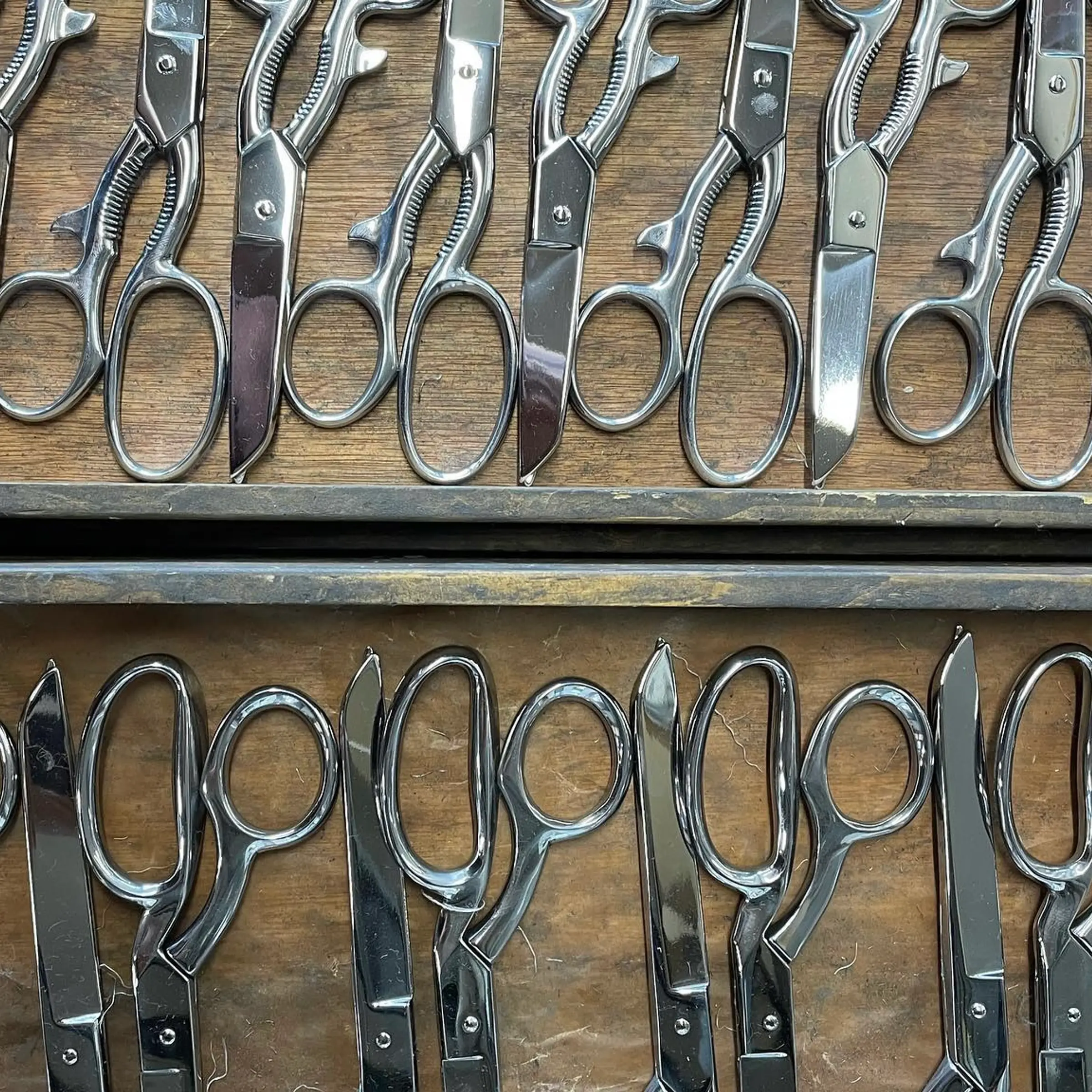 handmade scissors laying in a wooden tray