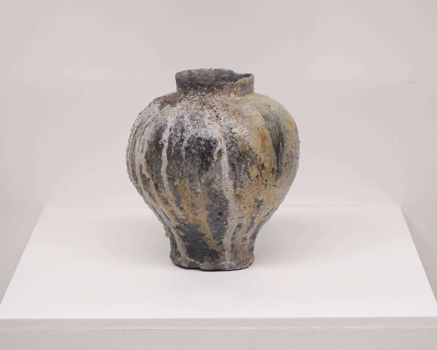 An anagram vase from Holly rose Morgan on a white plinth and background