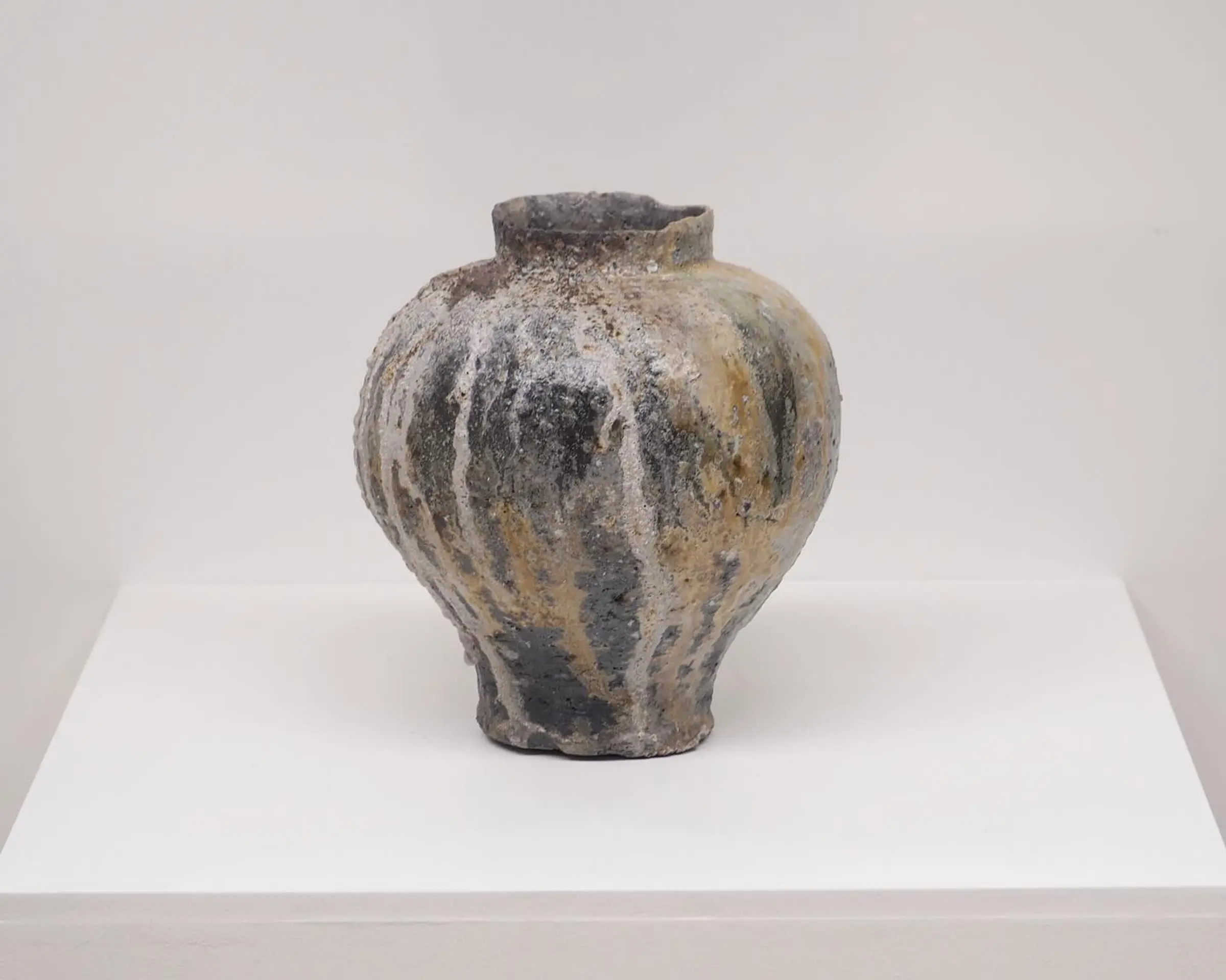An anagram vase from Holly rose Morgan on a white plinth and background