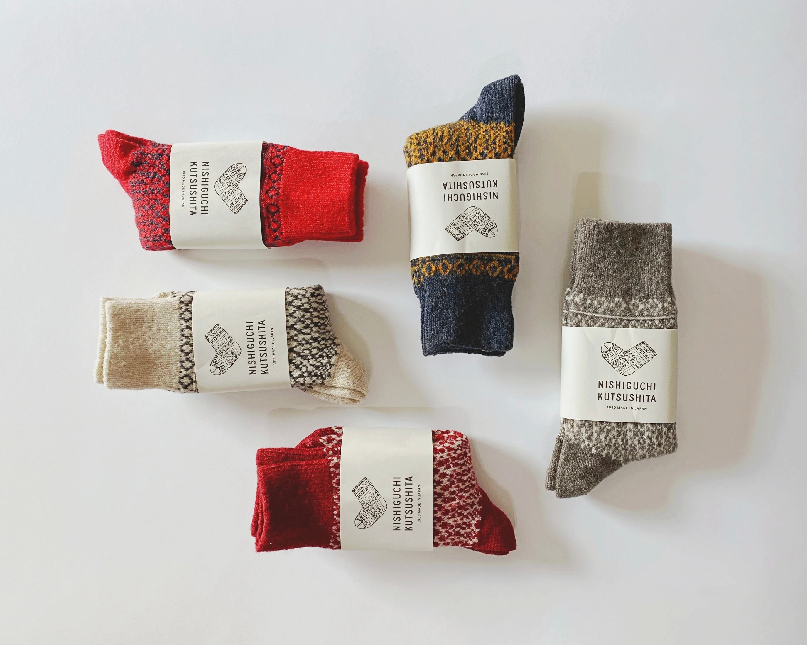 a collection of Oslo Wool Jacquard Socks laid out on a white background