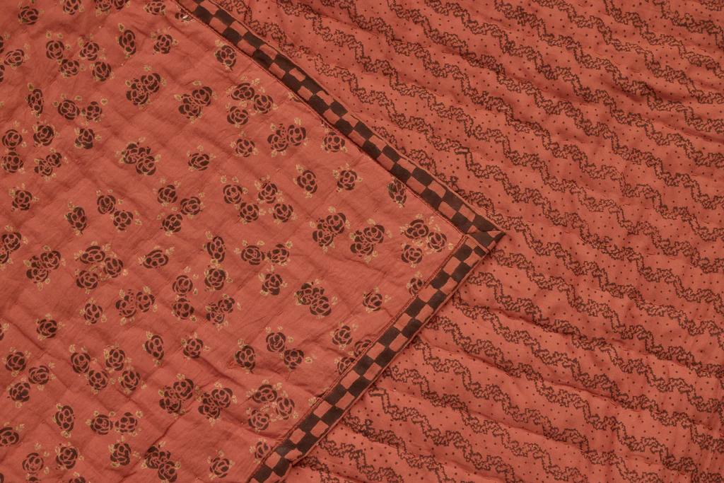 a close up of Studio Ford Marquise Quilt in rust and cacao colours