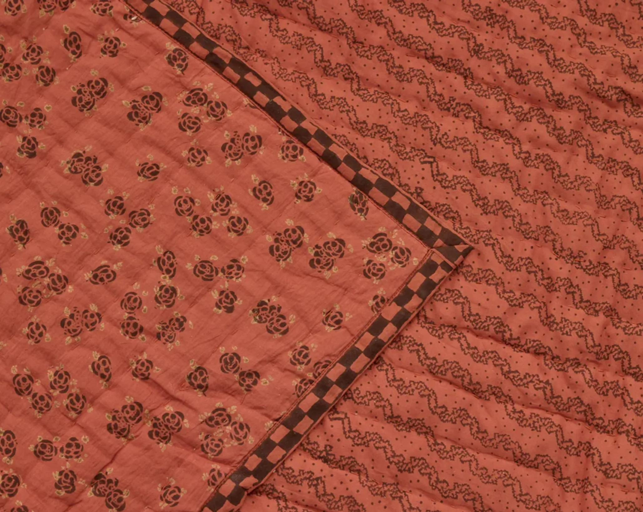 a close up of Studio Ford Marquise Quilt in rust and cacao colours