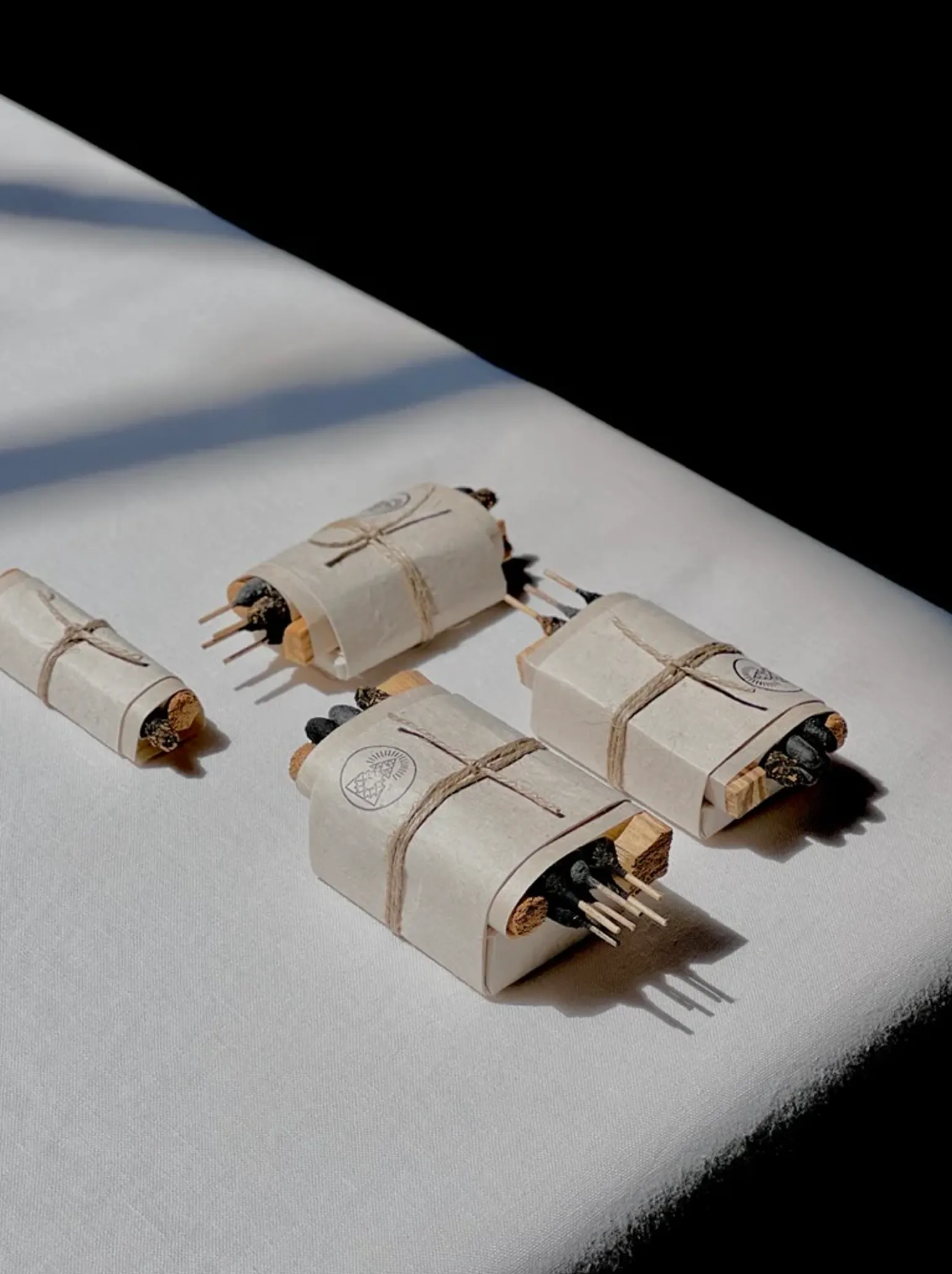 Incausa Bath and meditate bundles on table with a white linen table cloth background