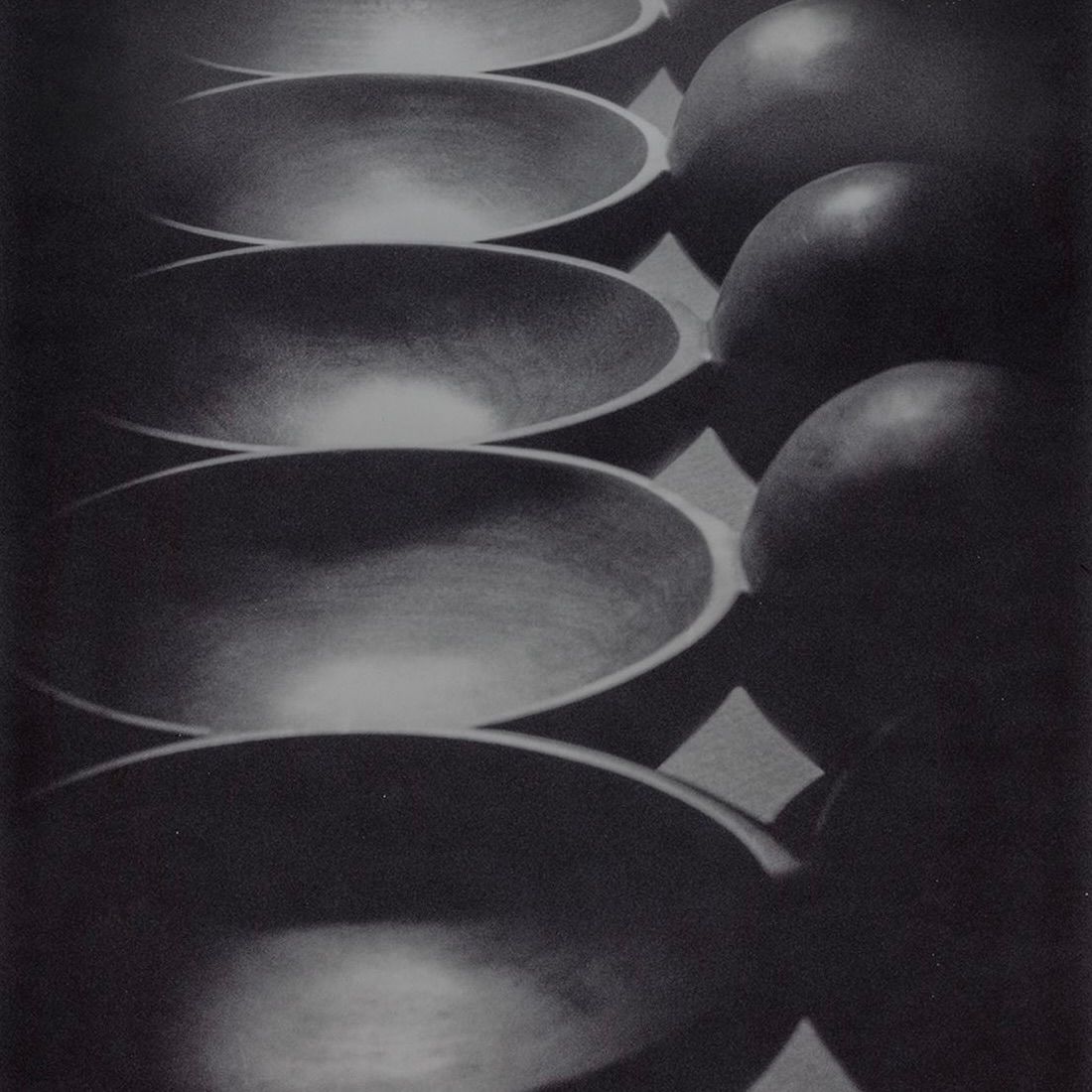 A black and white image of Auckland woodworker Courtney Petleys hand carved moon spoons in local Native New Zealand timber.