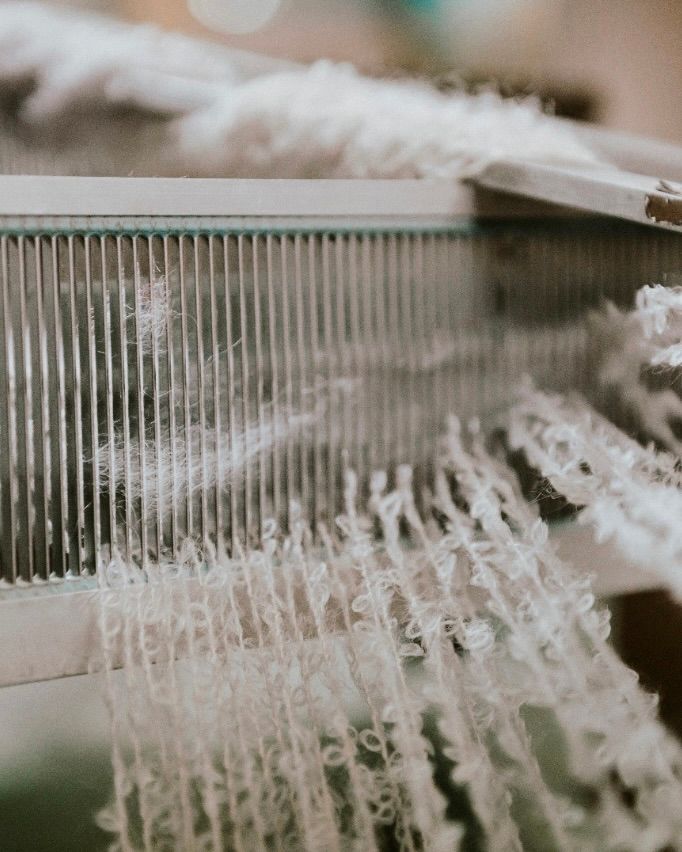 a process weaving photo of wool on a loom