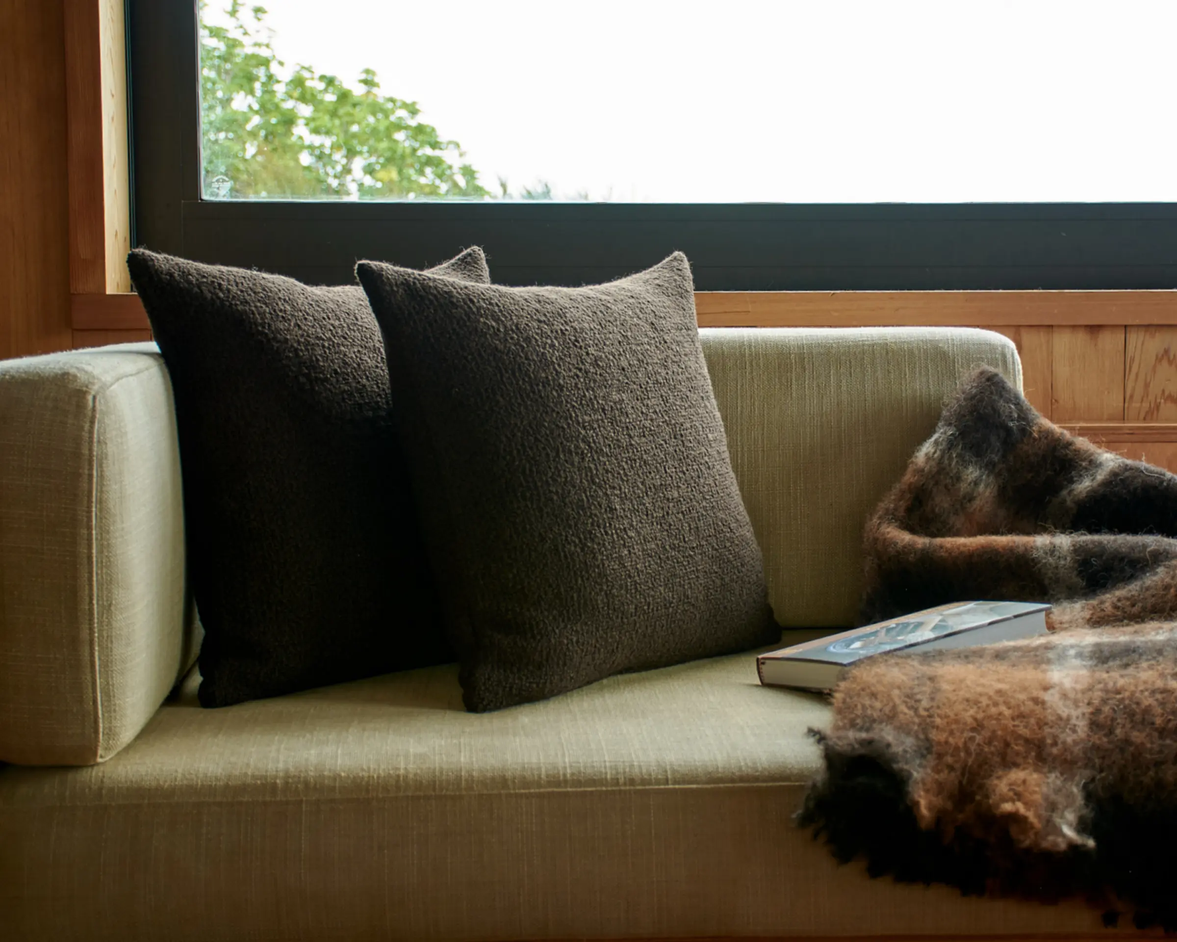 cushions on an inset couch infront of a window sill