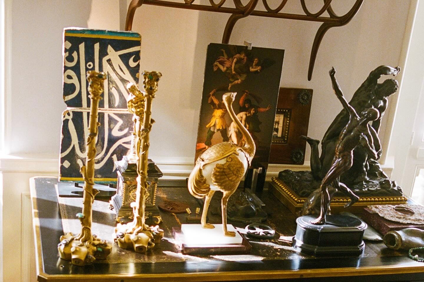a table desk filled with metal sculptures and figurines from Neptune magazine
