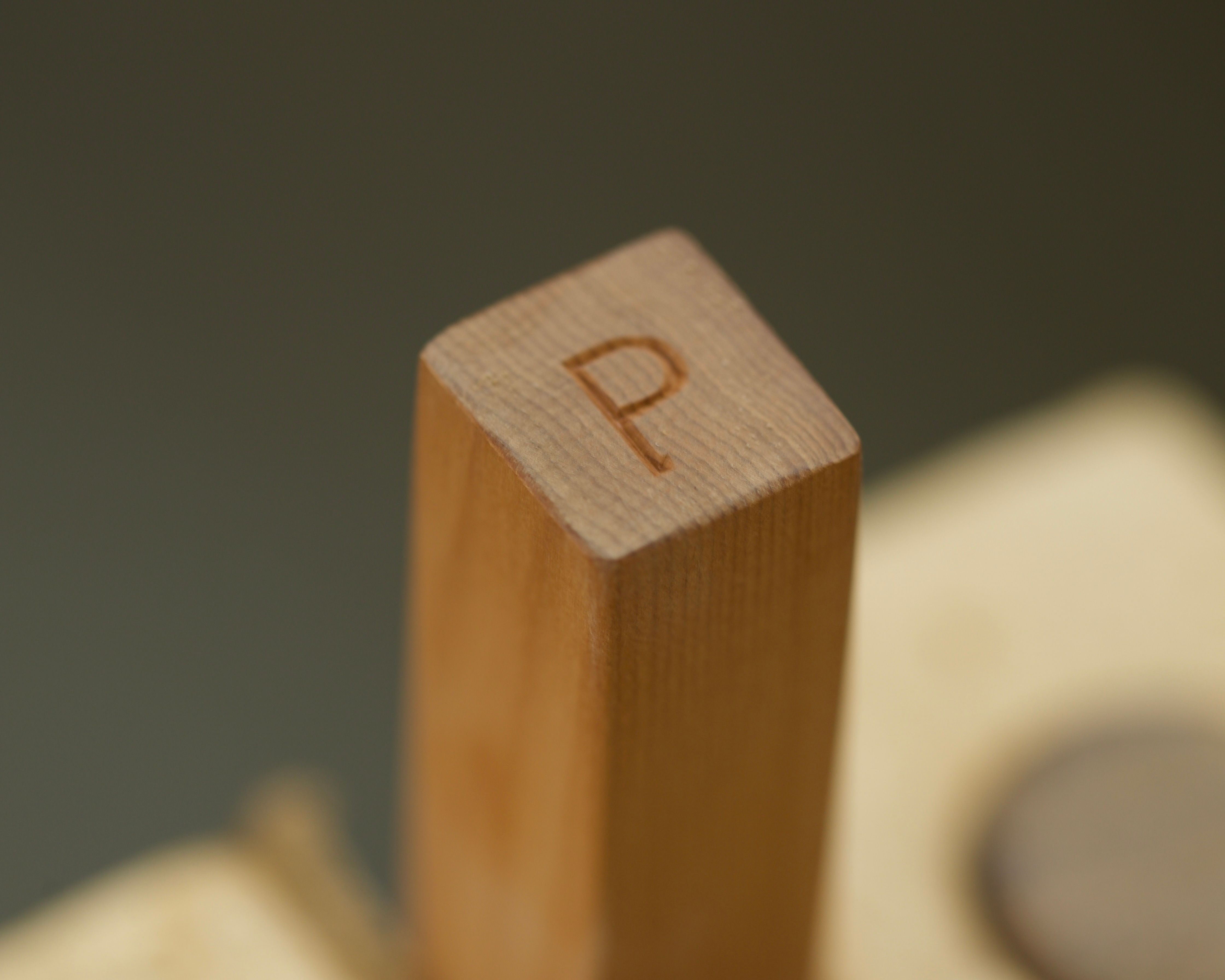 a detailed image of the end of one of Courtney Petleys kitchen utensils with her maker mark, hand carved in New Zealand 