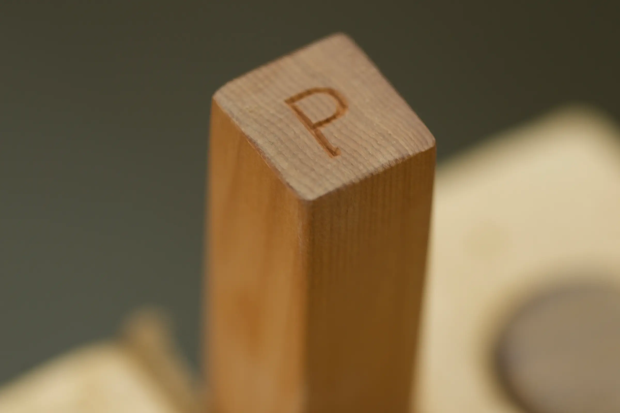 a detailed image of the end of one of Courtney Petleys kitchen utensils with her maker mark, hand carved in New Zealand