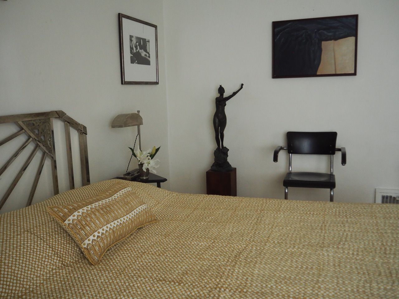 STUDIO FORD Aurea Block Printed Cotton Quilt on a bed in a bedroom setting.