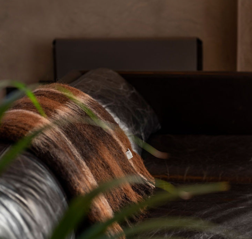Alpaca throw on a black leather couch 