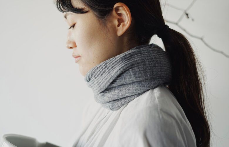 Super-soft snood made with fine, high-quality merino wool worn styled on a mode with a neutral background