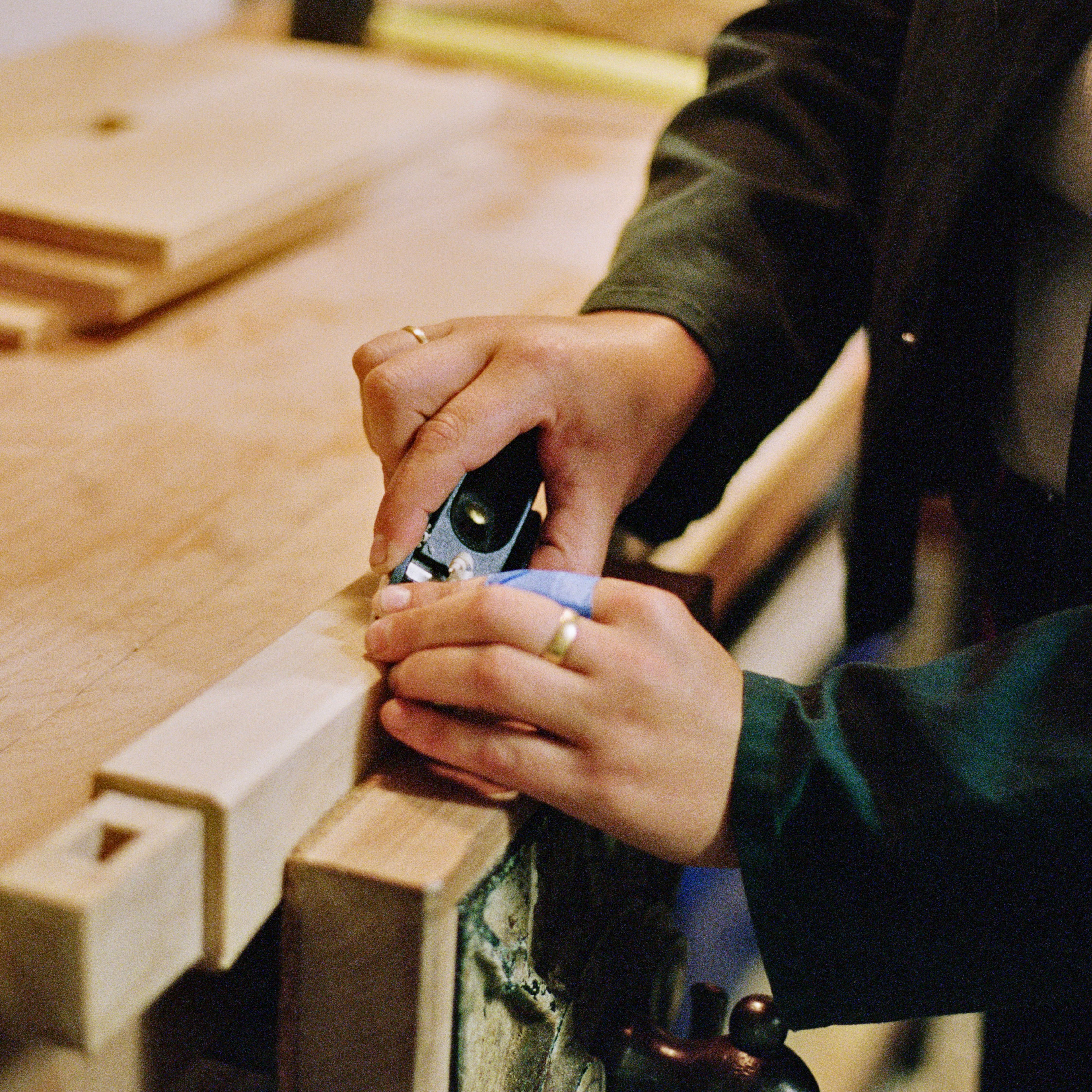 Josephine Jelicich, in a workroom hand carving a piece of wood