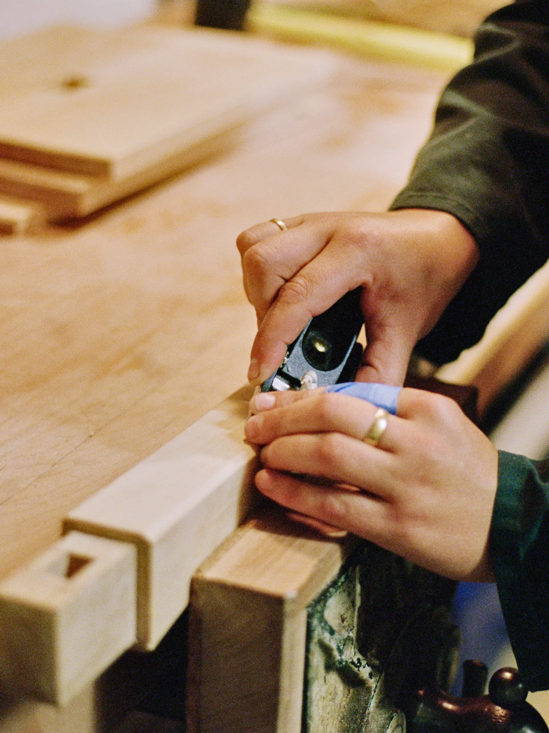 Josephine Jelicich, in a workroom hand carving a piece of wood