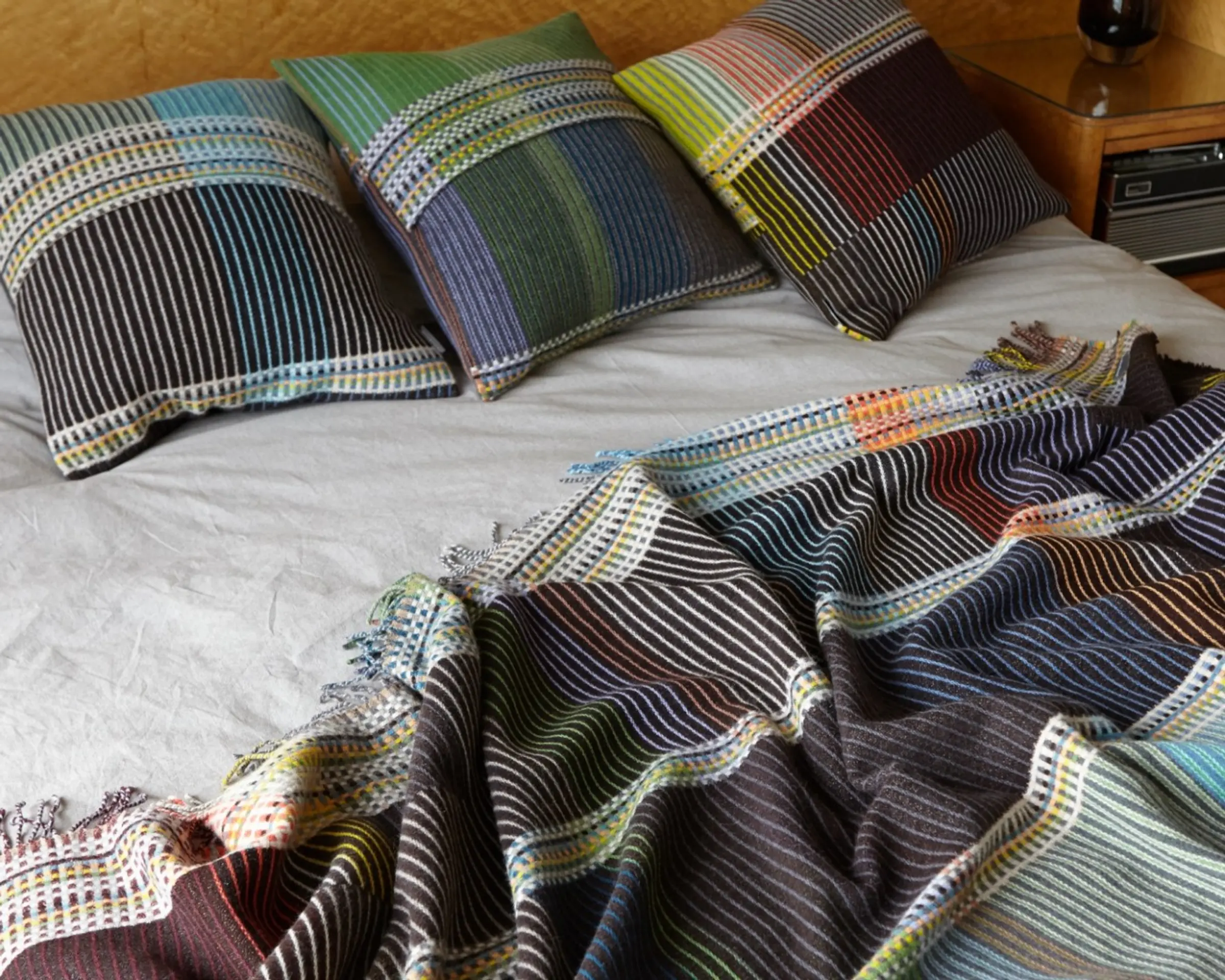 wool cushions and throw on a bed