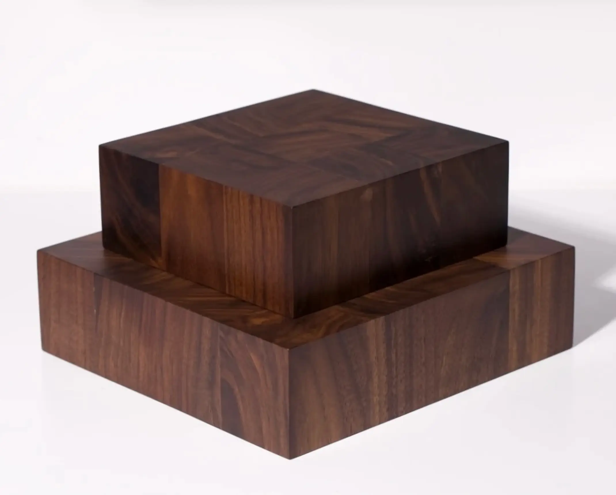 Two of Courtney Petleys end grain chopping boards stacked ontop of each other, both in a deep rich tone of Walnut, hand made in Auckland, New Zealand