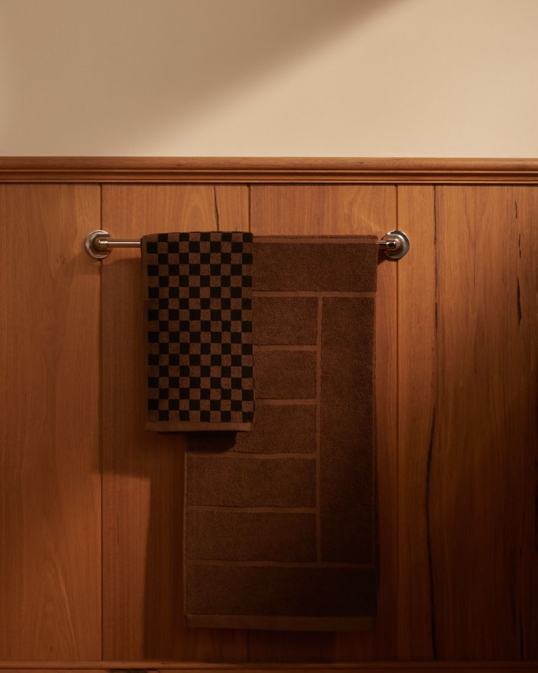 Bath towels hanging on a rail in a bathroom