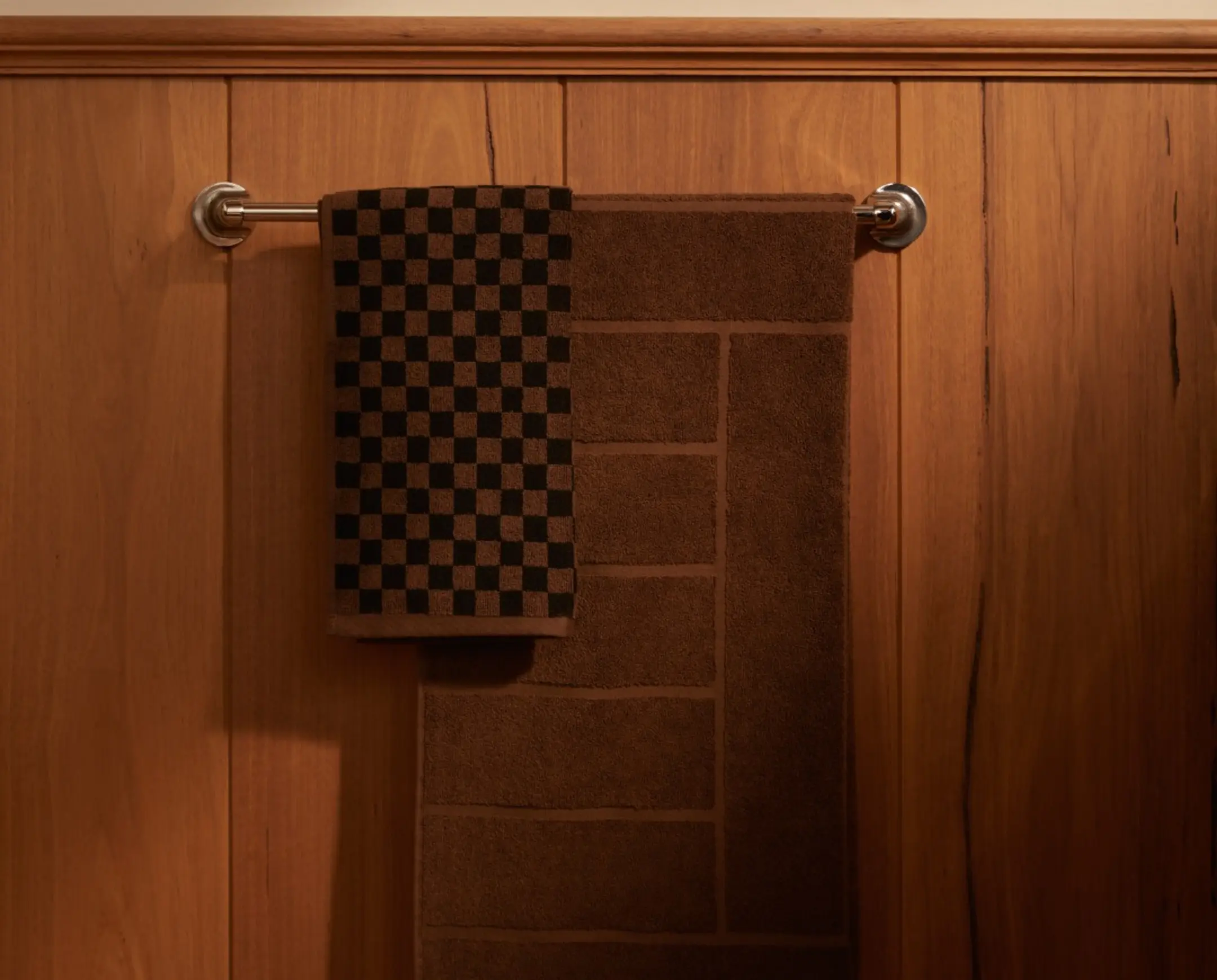 Bath towels hanging on a rail in a bathroom