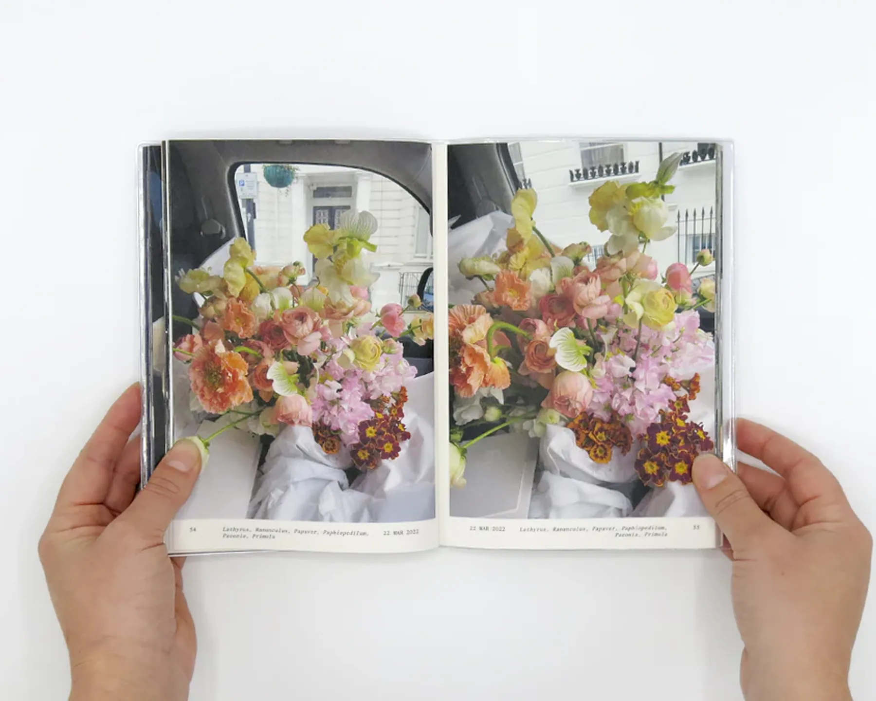 The book Flowers in the front seat by Simone Gooch opened showing images from inside of the book of a large bouquet of flowers sitting in her cars front seat