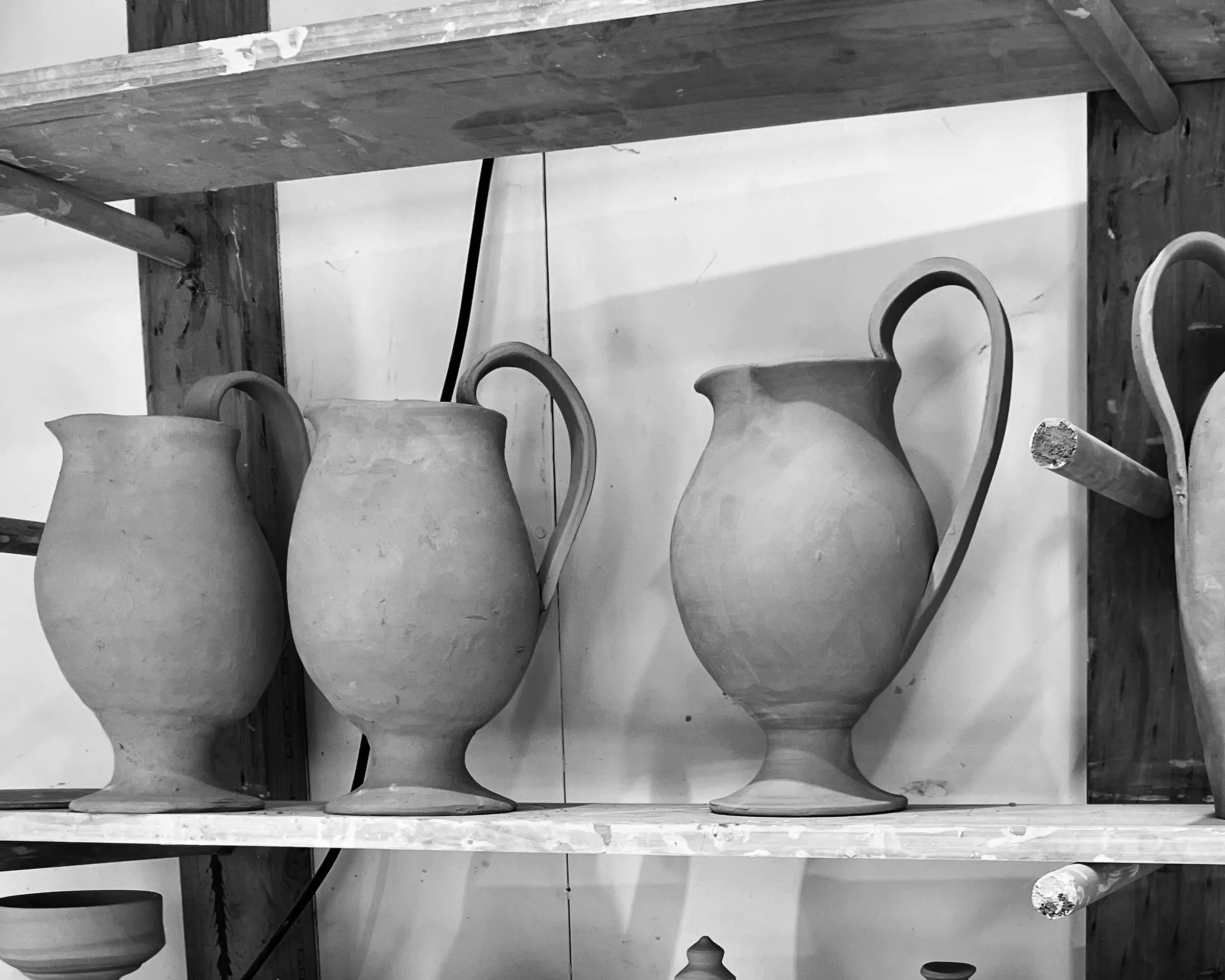 ceramic jugs on a drying rack in Kirsten dry burghs studio