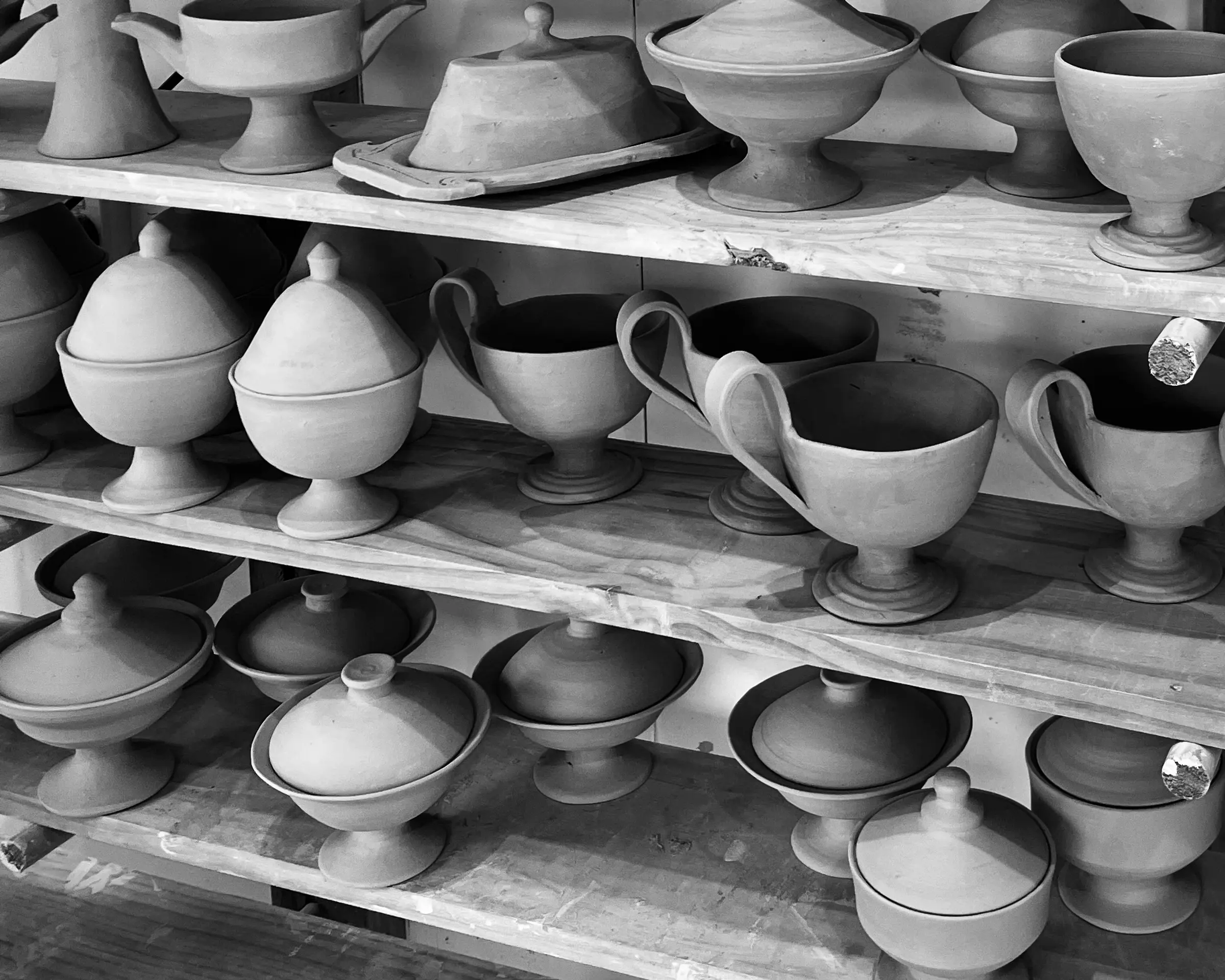 black and white image of Kirsten dry burghs blackware collection of ceramic vessels- cups, chalice, lidded bowls