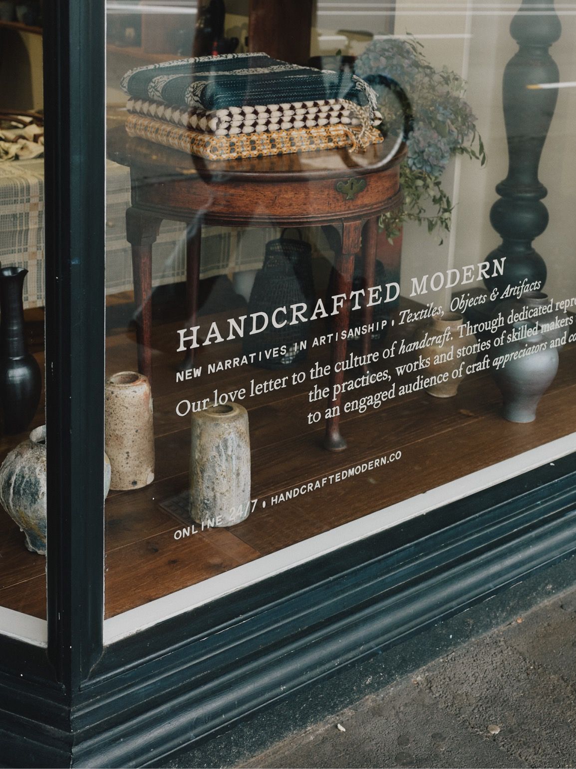 Hand-painted storefront lettering at Handcrafted Modern in Ponsonby, Auckland, inviting visitors into our contemporary craft and design store.