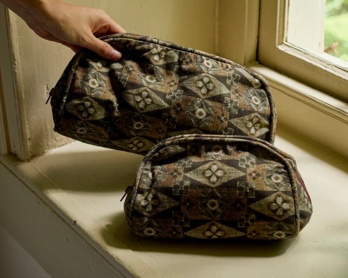 Autumn Sonata Emile wash bags on a window ledge surface