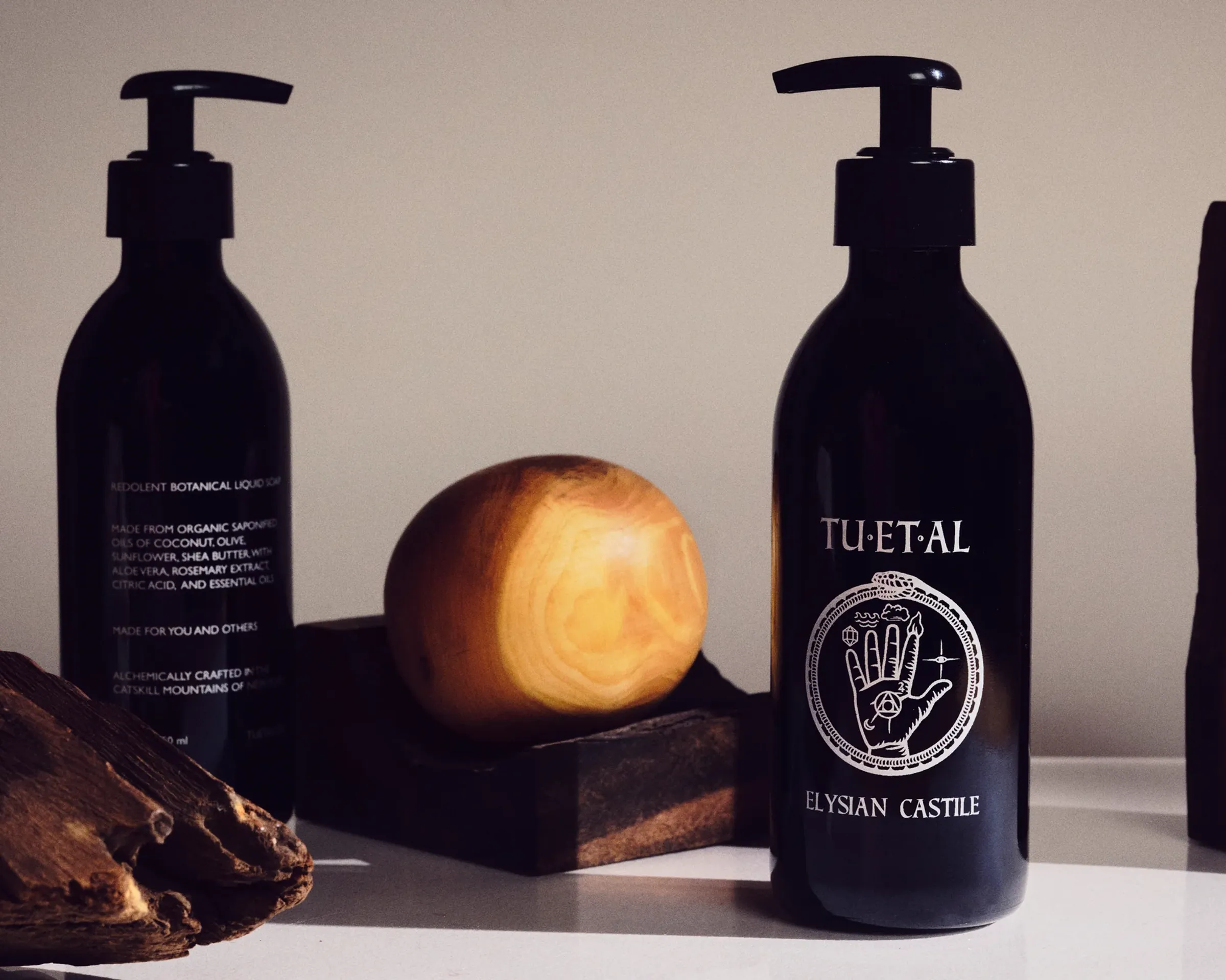 bottles of liquid soap with wooden objets in-between