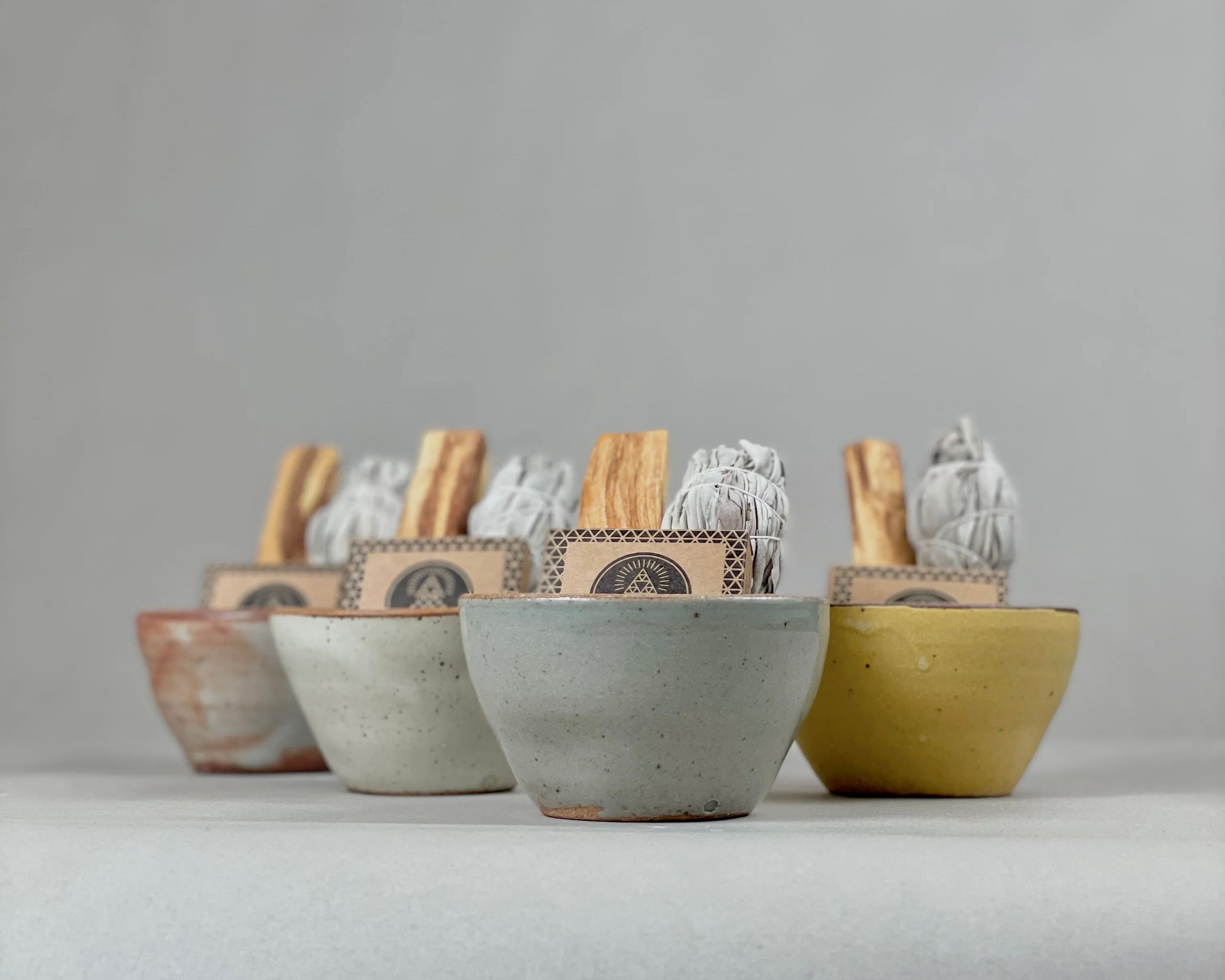 White Sage & Palo Santo Smudge Sets on a neutral grey background 