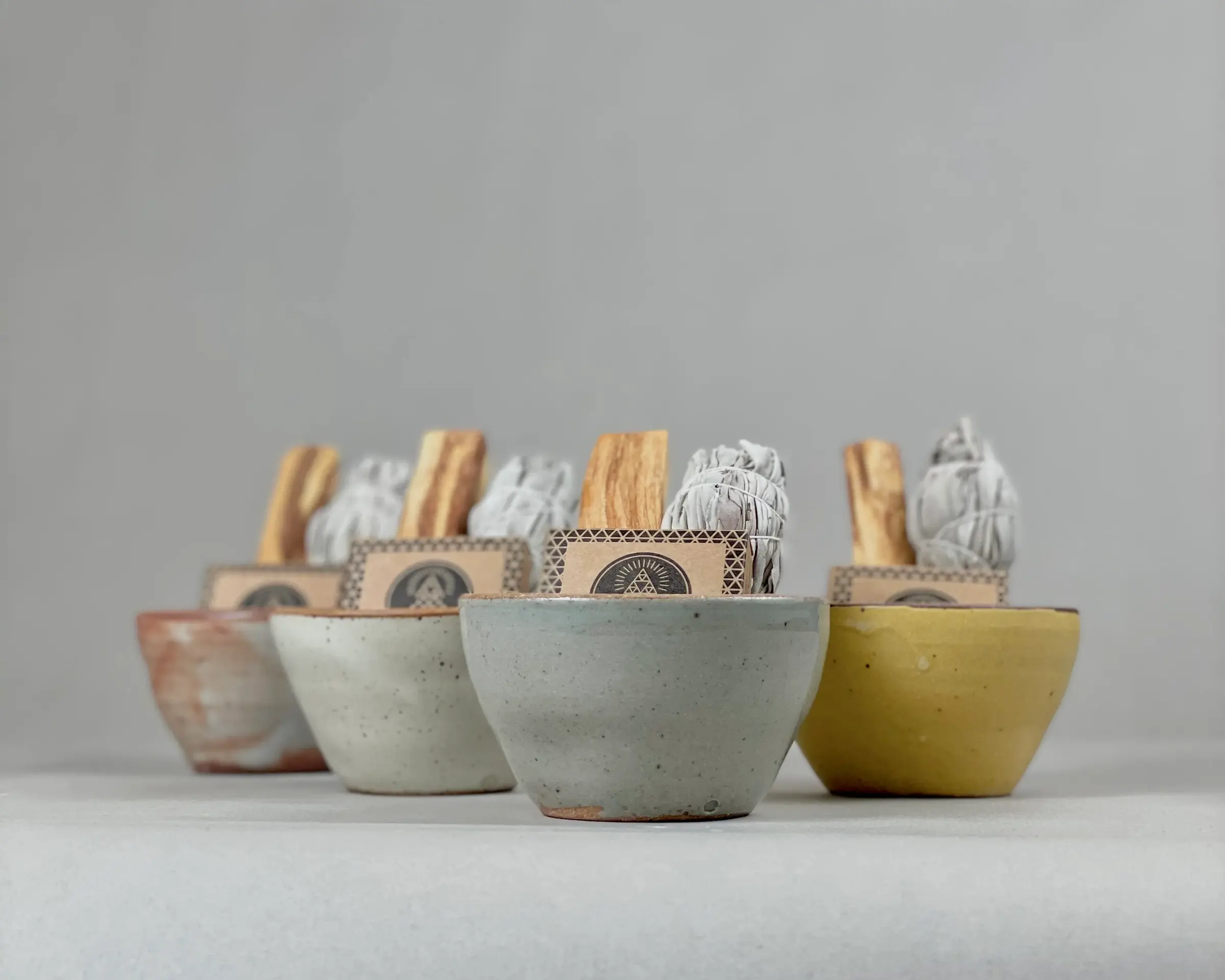 White Sage & Palo Santo Smudge Sets on a neutral grey background