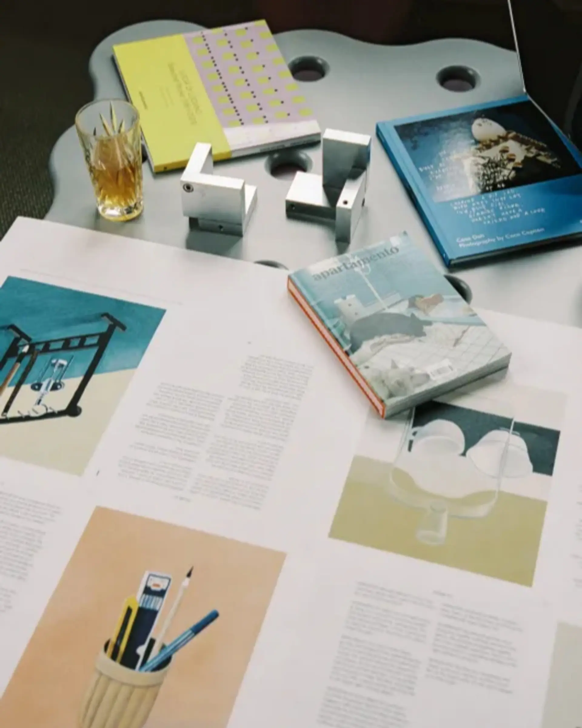 pages of books laid on a table planning the layout
