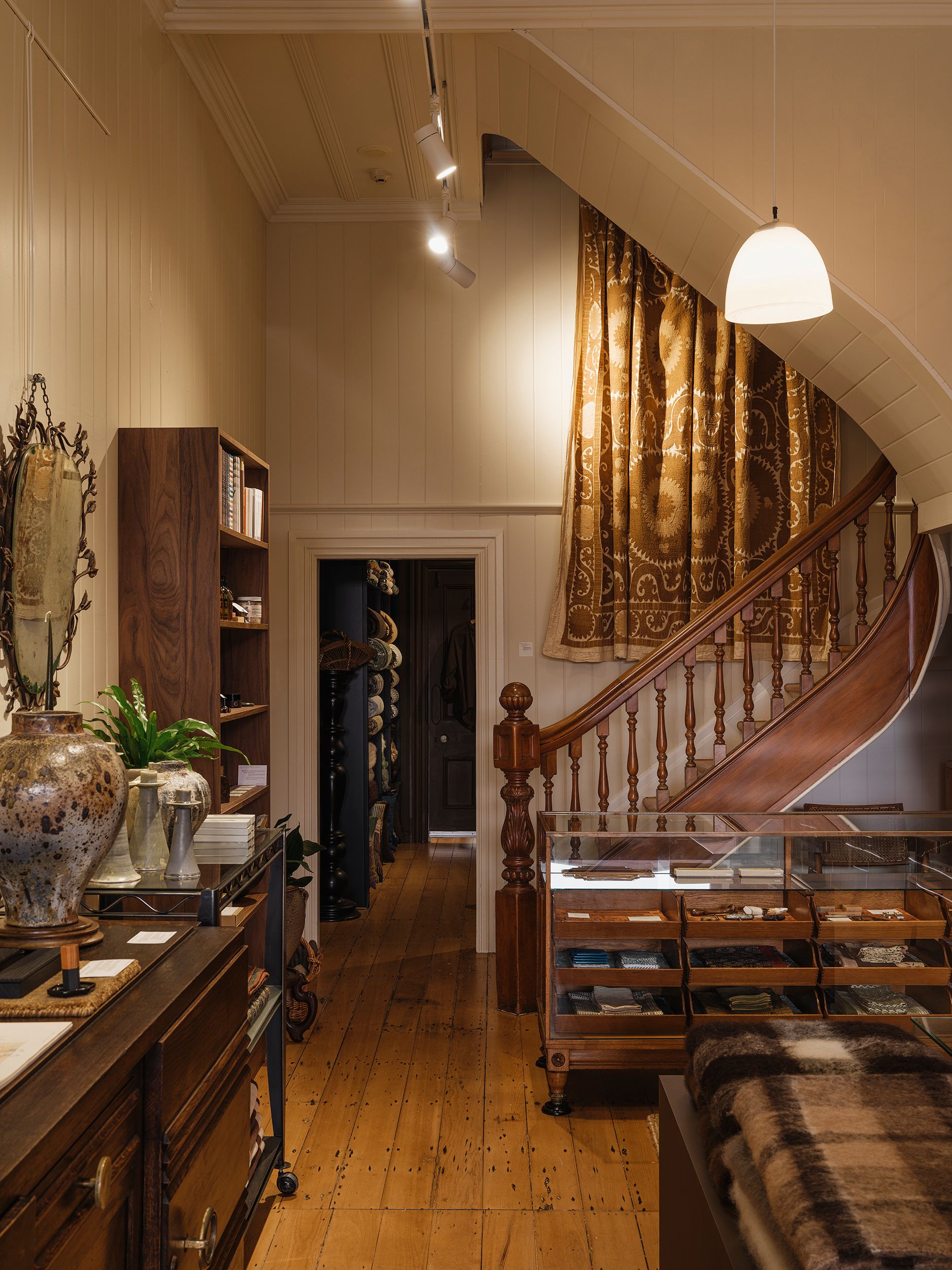 Wide view of Handcrafted Modern's heritage interior in Ponsonby, Auckland, showing the original timber staircase, contemporary craft displays and the transition from the Deuce gallery to the Forest Floor textile room.